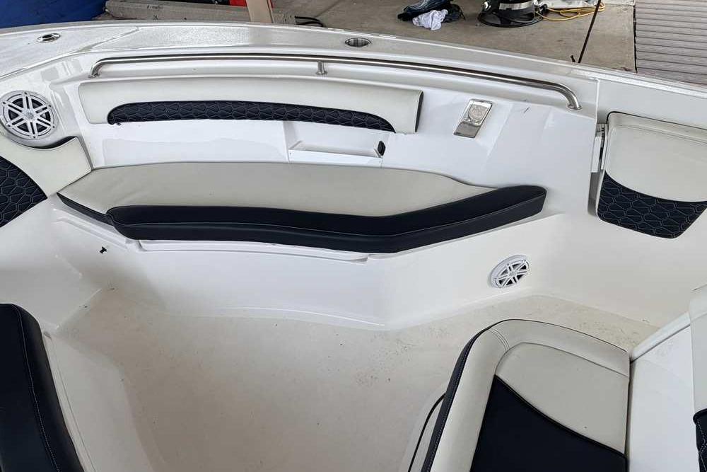 2024 Tidewater 232 LXF boat interior with cushioned seating and speaker system.