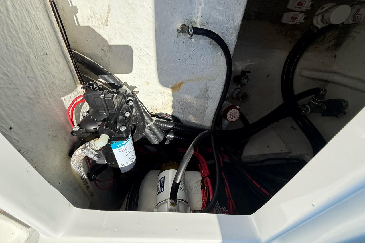 Electrical and plumbing components inside a 2021 Custom Infusion 34 CC boat.