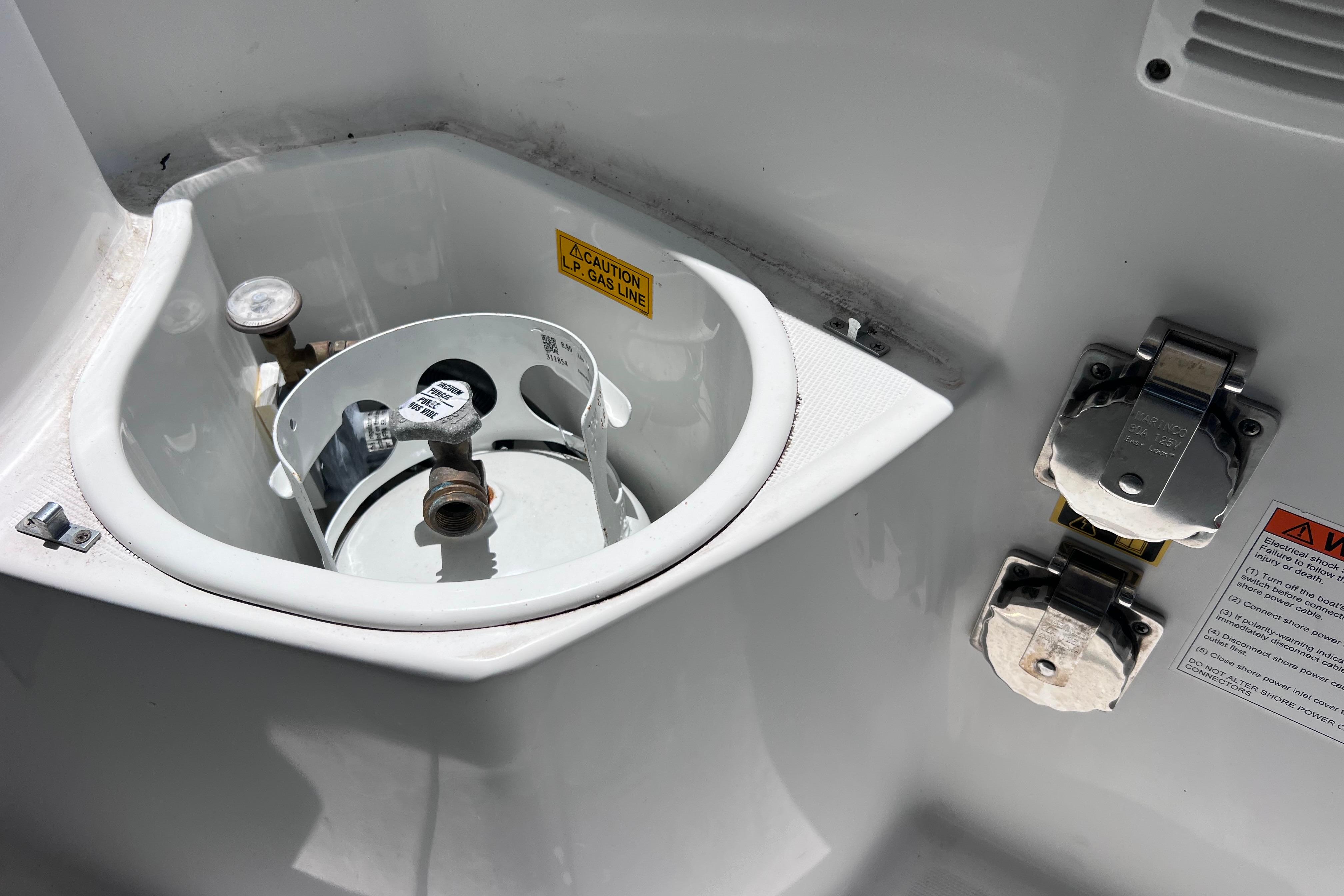 Propane tank compartment on 2021 Jeanneau NC Weekender 795 Series 2 boat.