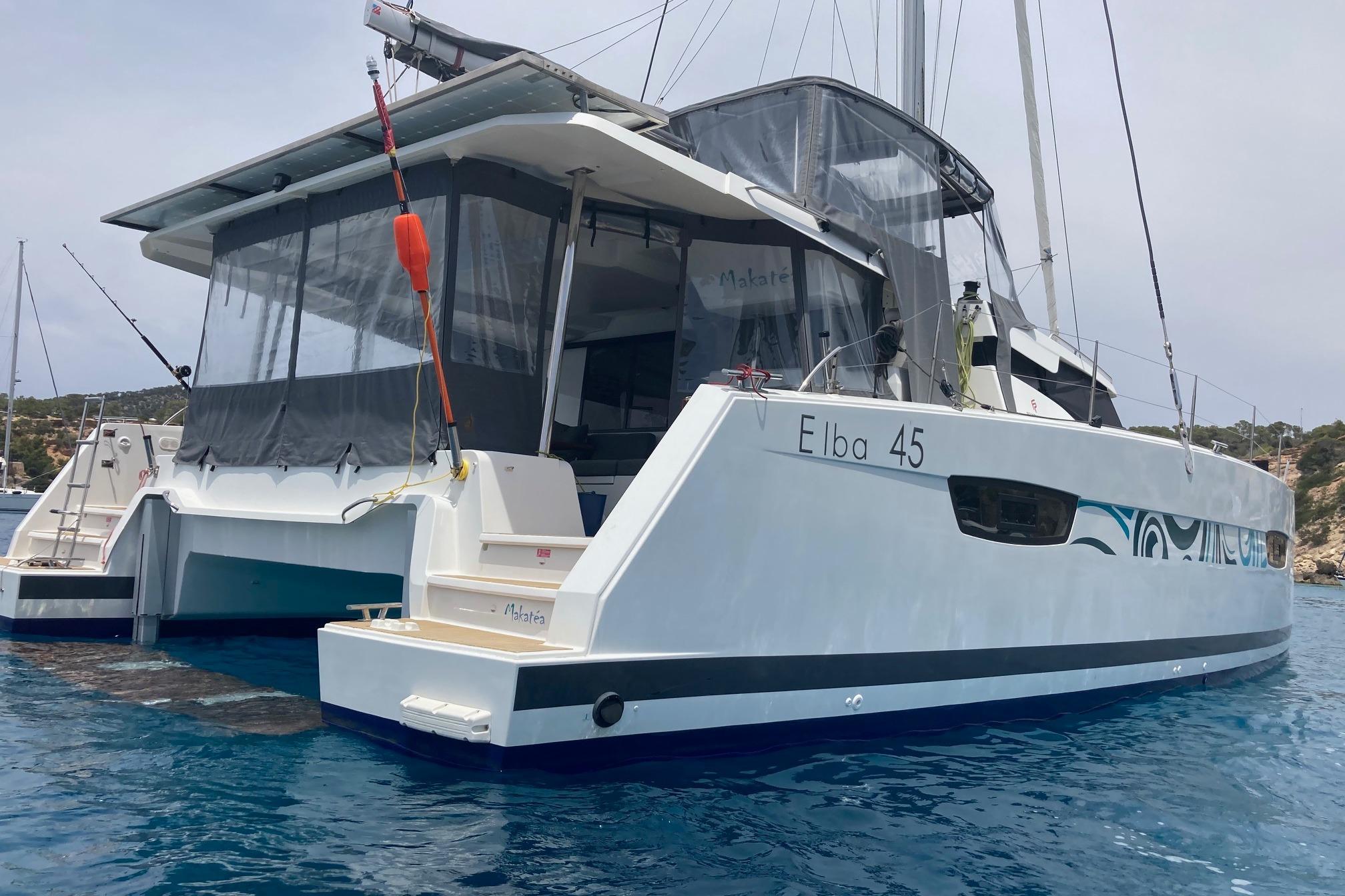 2021 Fountaine Pajot Catamaran Elba 45 anchored in clear blue water.