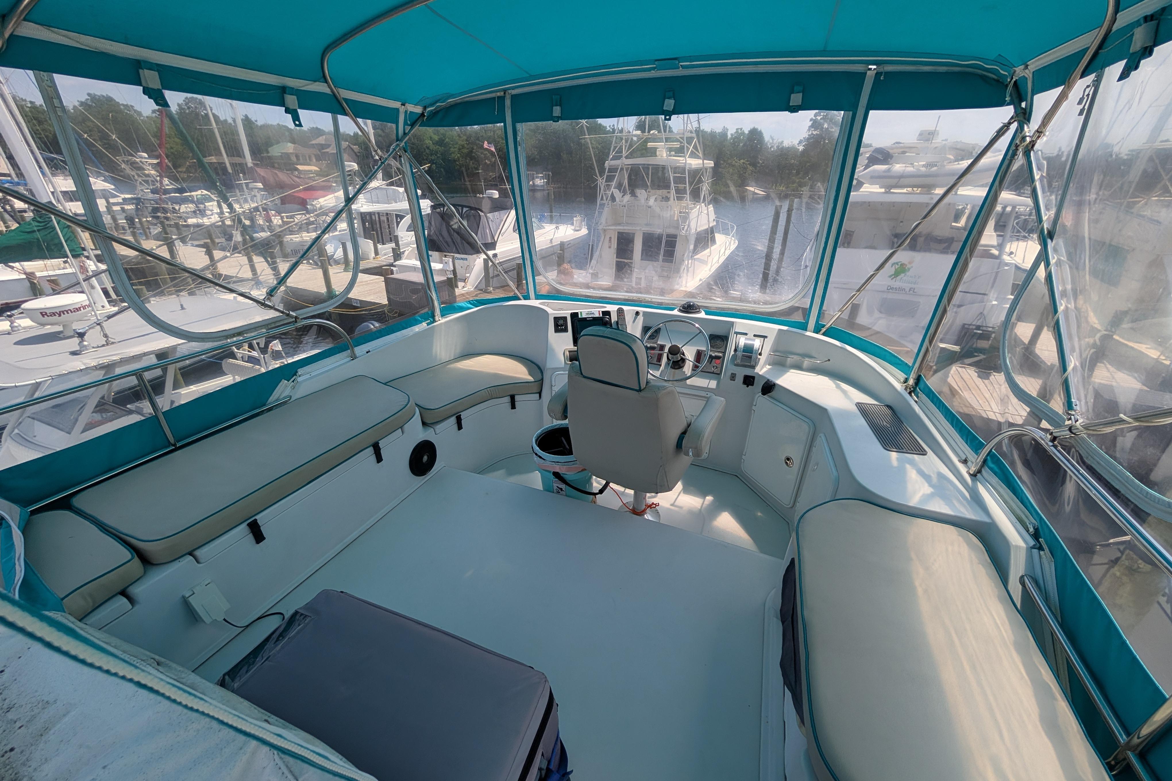 Interior view of 2004 PDQ 34 Powercat boat with blue canopy and seating.
