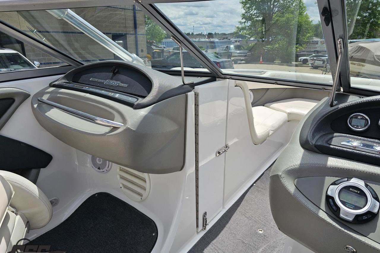 Interior of a 2010 Cobalt 232 WSS boat, featuring sleek dashboard and seating.