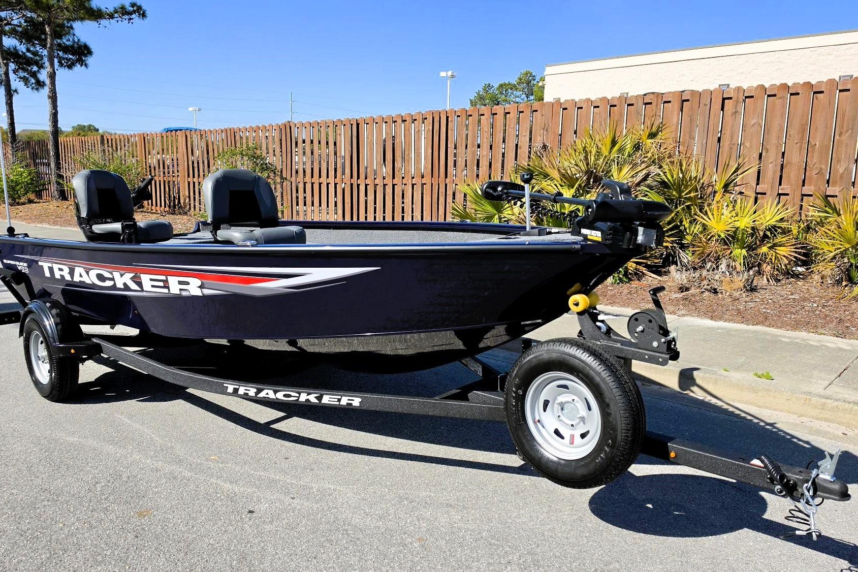 2026 Tracker Super Guide V-16 T boat on trailer, parked outdoors.