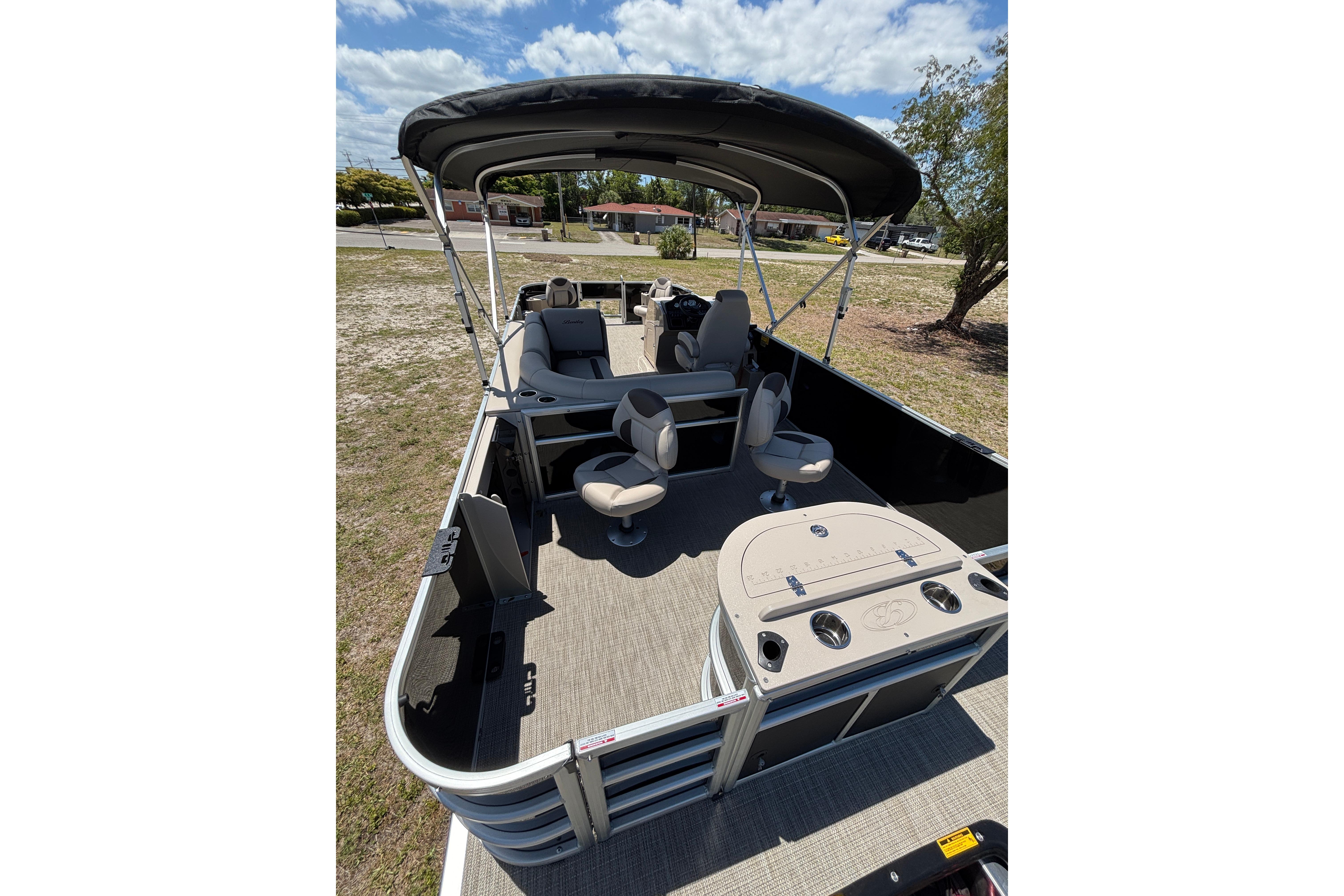 2026 Bentley Pontoons Fish 243 4-Point with seating area and canopy.
