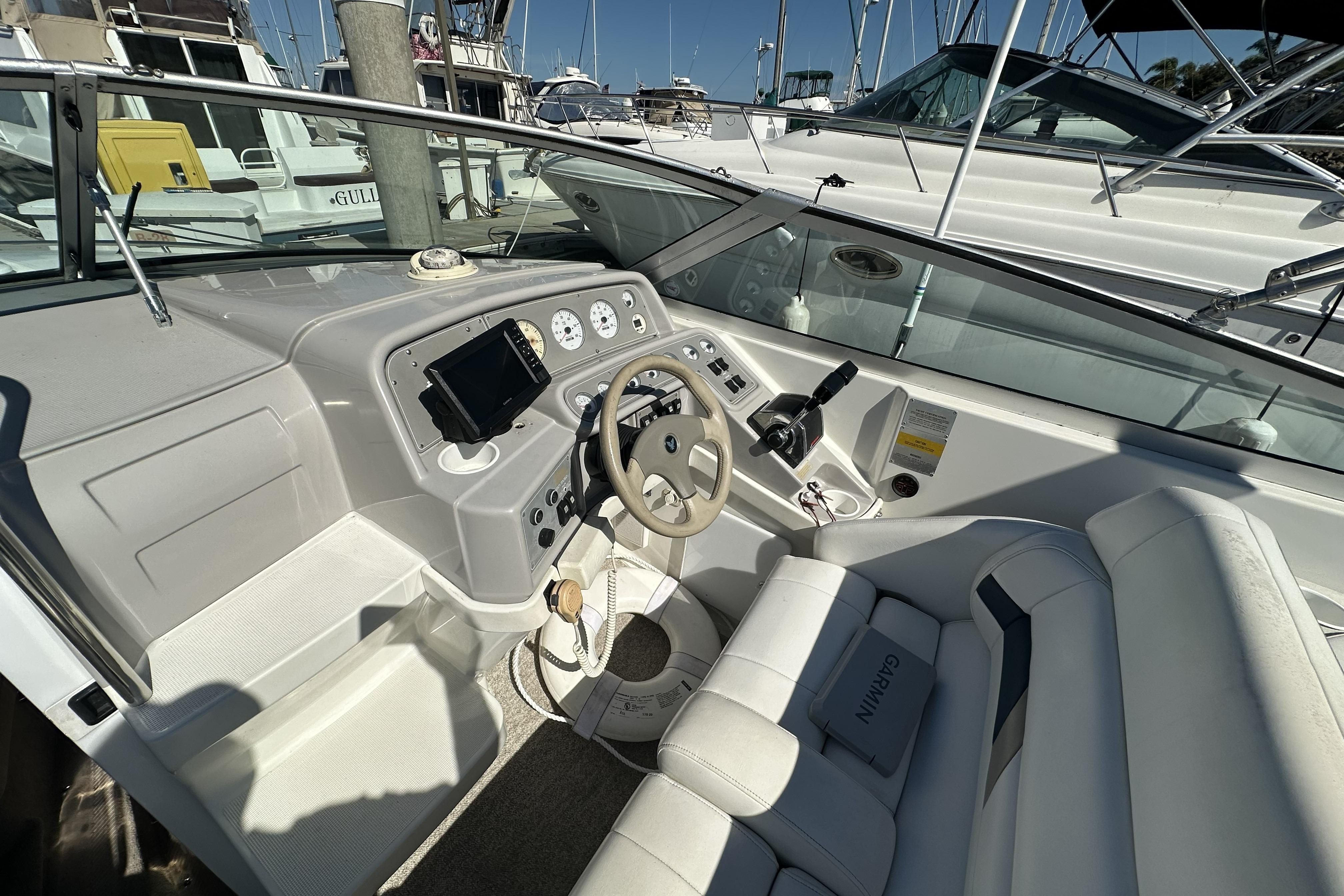 Cockpit of a 2000 Formula 280 Sun Sport boat with steering wheel and controls.