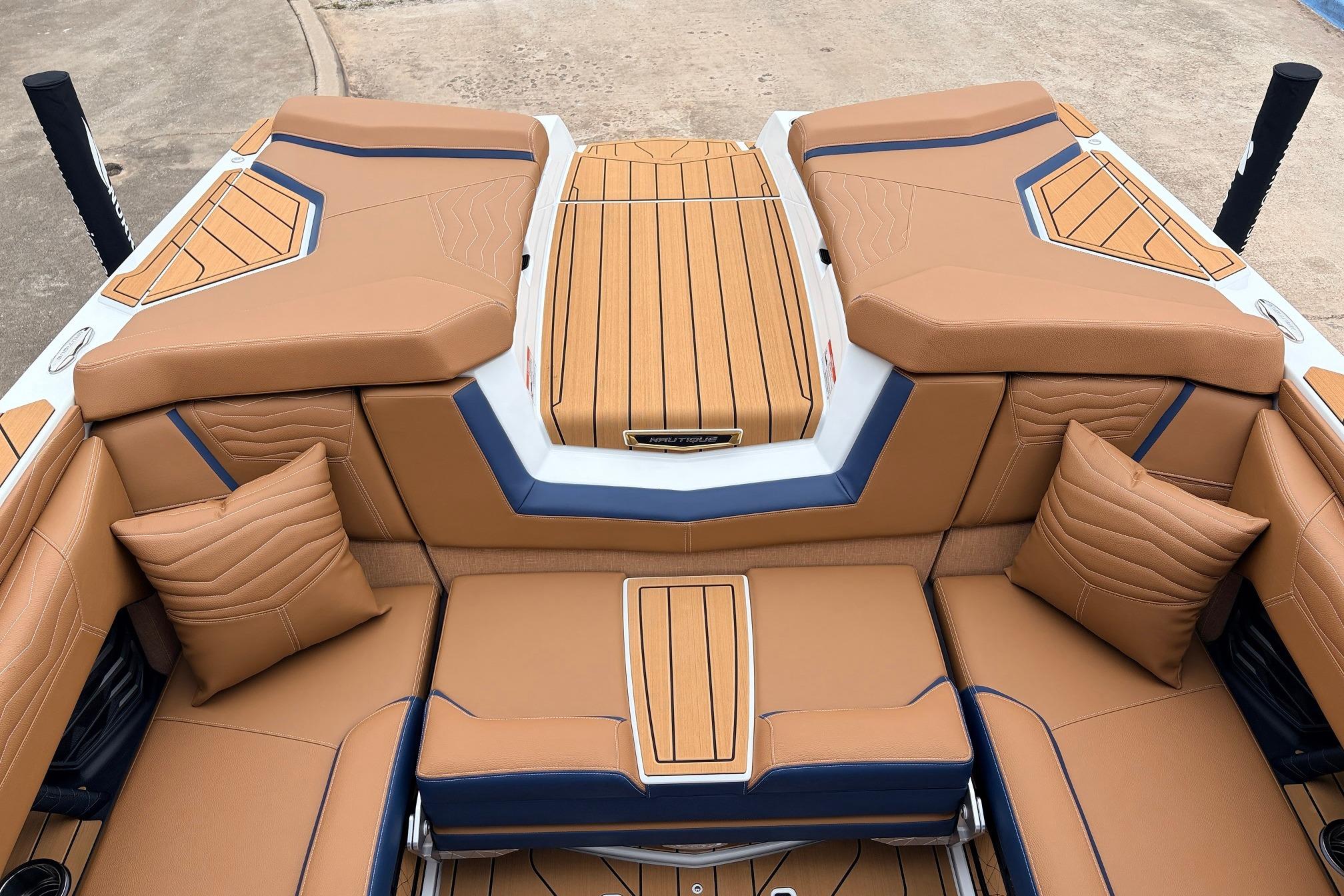 2026 Nautique Super Air Nautique G25 boat interior with tan and blue upholstery.