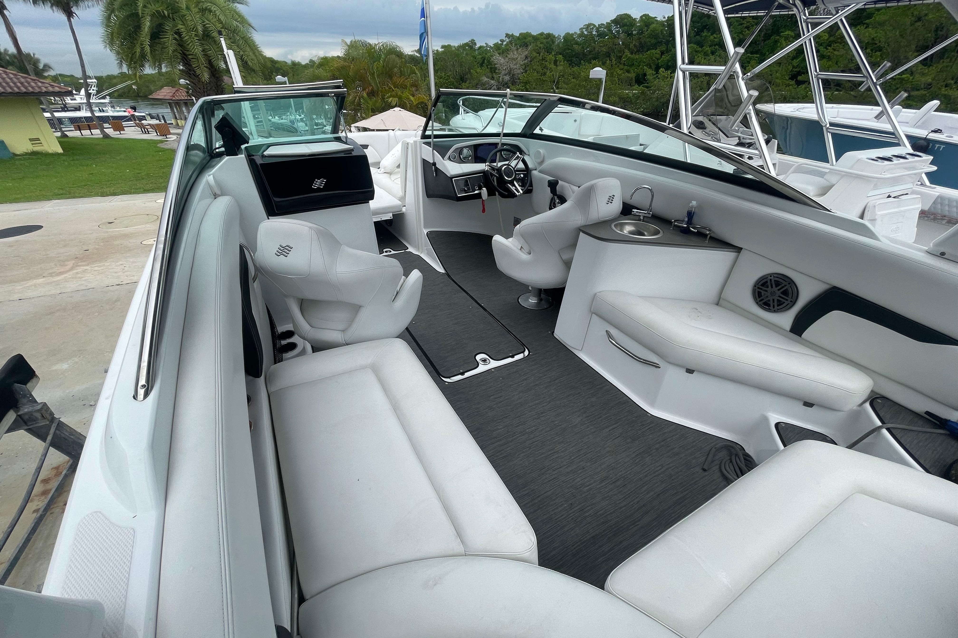 2022 Four Winns HD8 OB boat interior with white seating and modern dashboard.