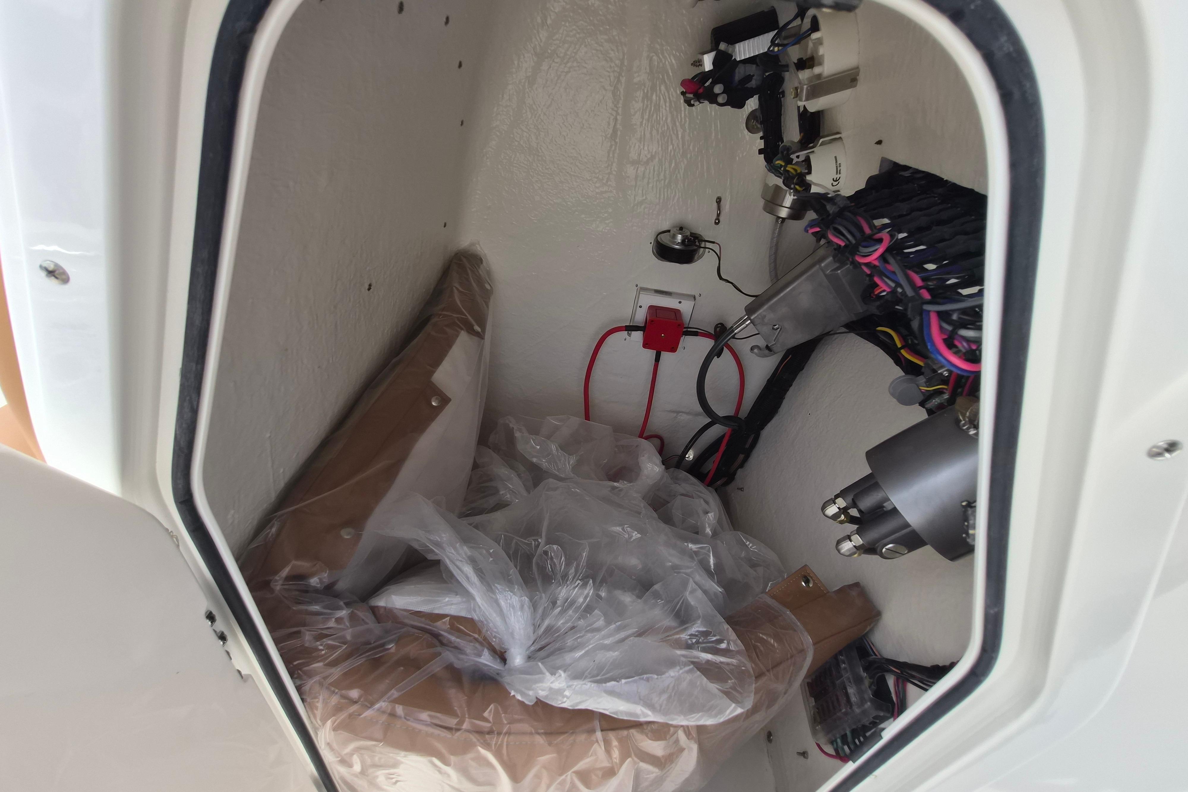 Interior view of 2026 Key West 189 FS boat compartment with wiring and equipment.