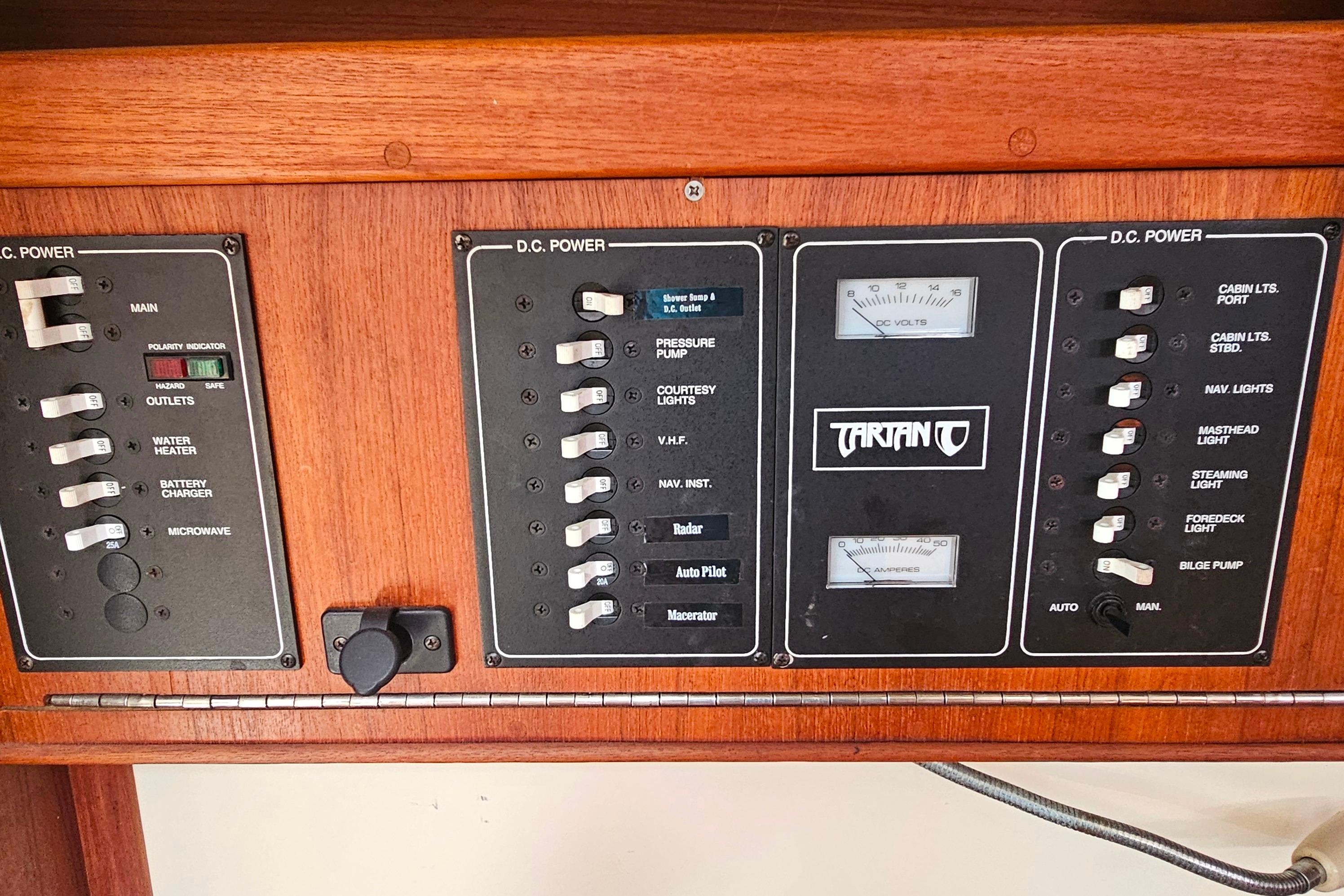Control panel of a 1994 Tartan 3100 boat with various switches and gauges.