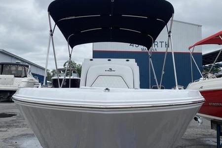 2025 Stingray 173CC boat with canopy at marina, front view.
