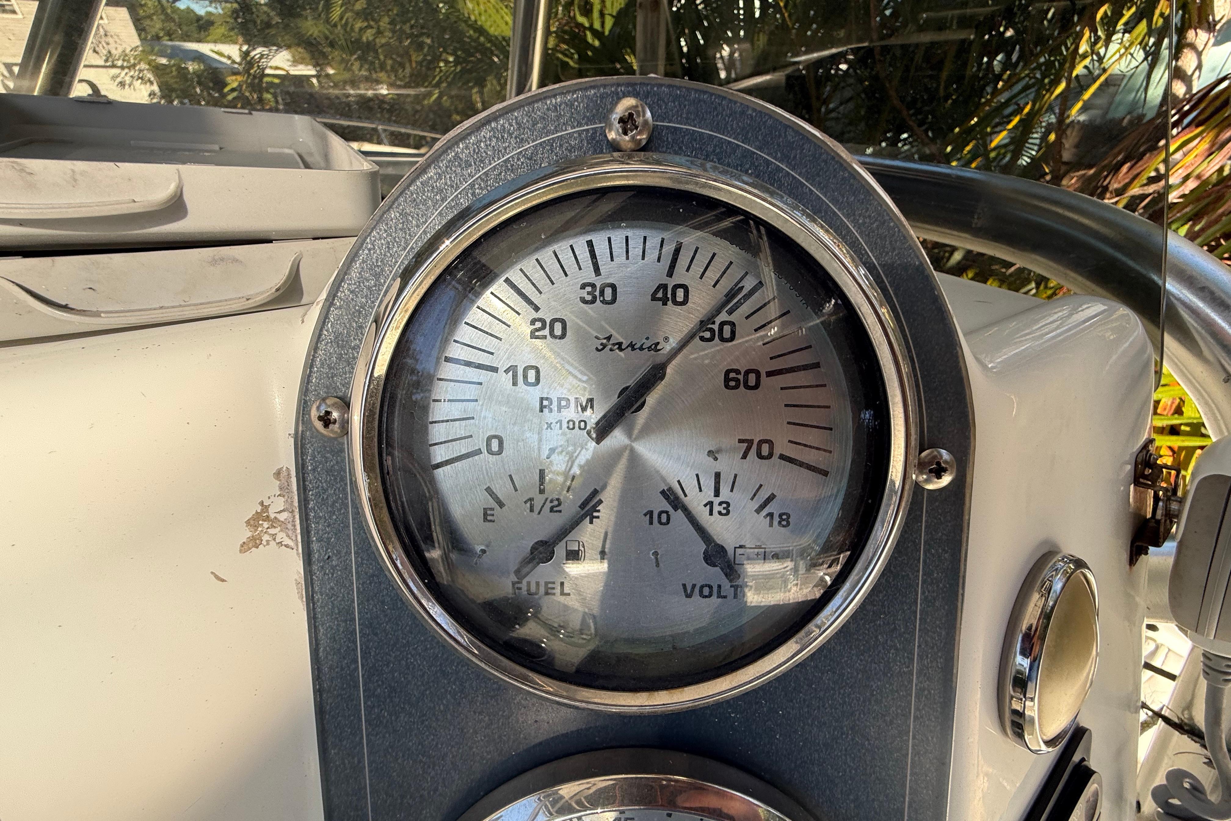 Close-up of a 2002 Fishmaster 212 Travis Edition boat tachometer and fuel gauge.