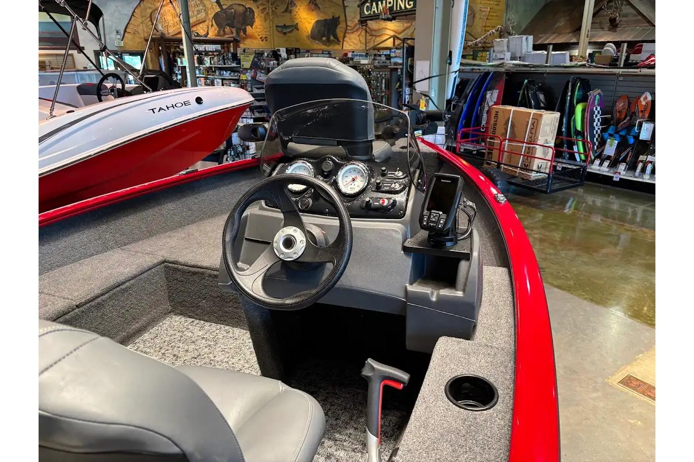 Interior of 2026 Tracker Super Guide V-16 SC boat with steering wheel and dashboard.