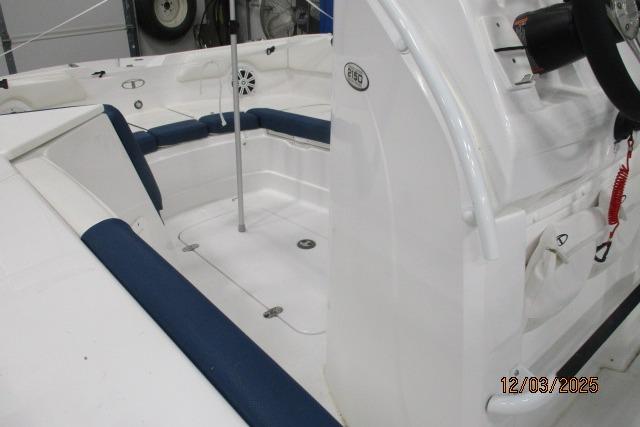 2024 Tahoe 2150 CC boat interior with blue seating and steering console.