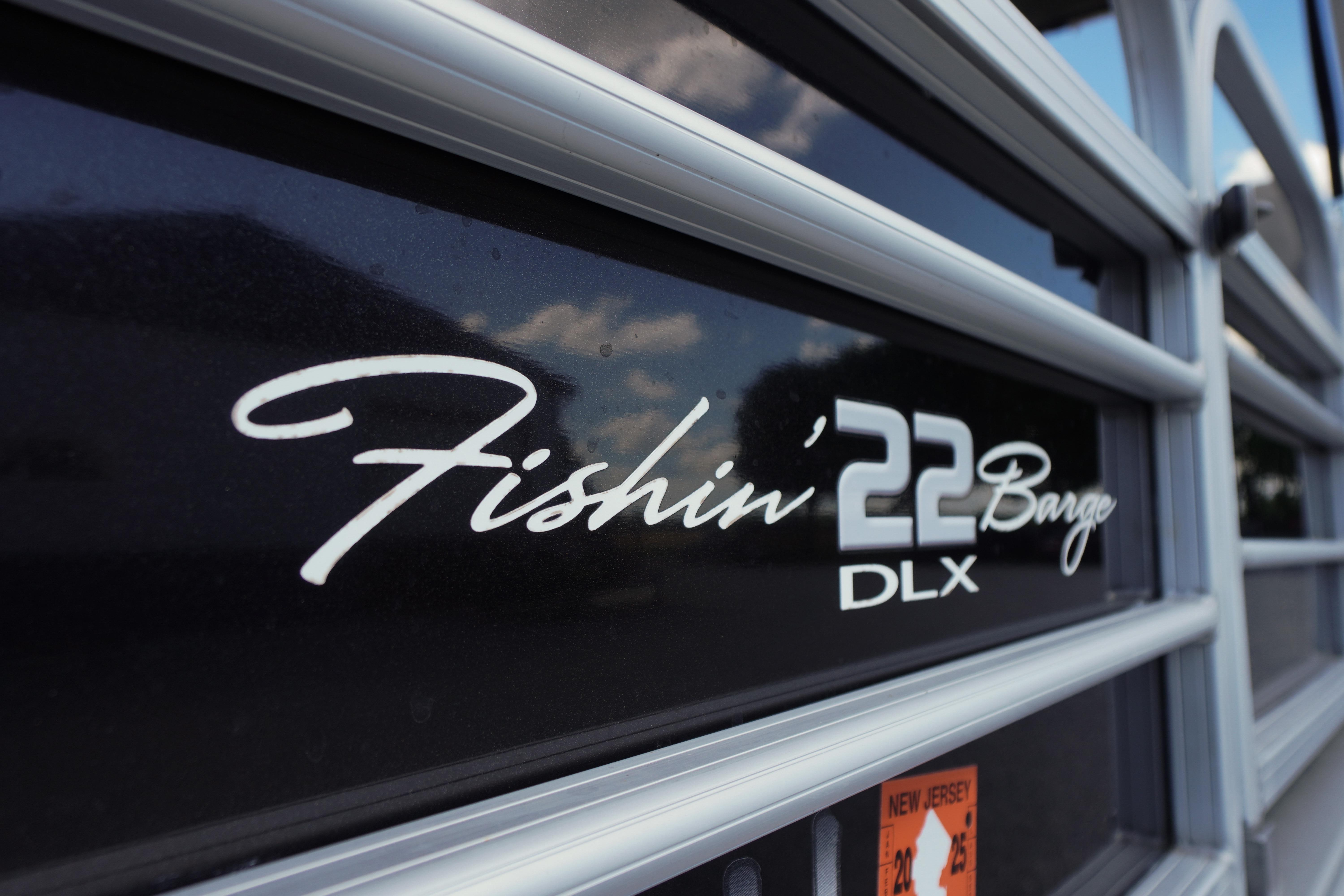 2019 SUNTRACKER Fishin' Barge 22 DLX logo on boat exterior.