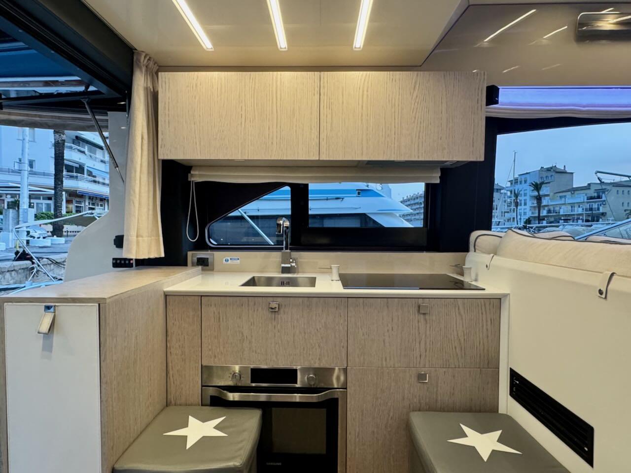 Modern kitchen interior of 2017 Cranchi E 52 F yacht with sleek cabinetry and appliances.