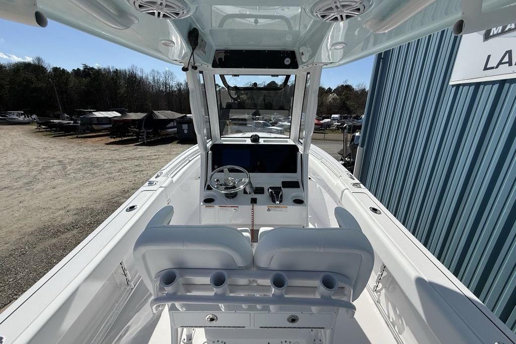2026 Sportsman Open 232 Center Console boat interior with steering wheel and seating.