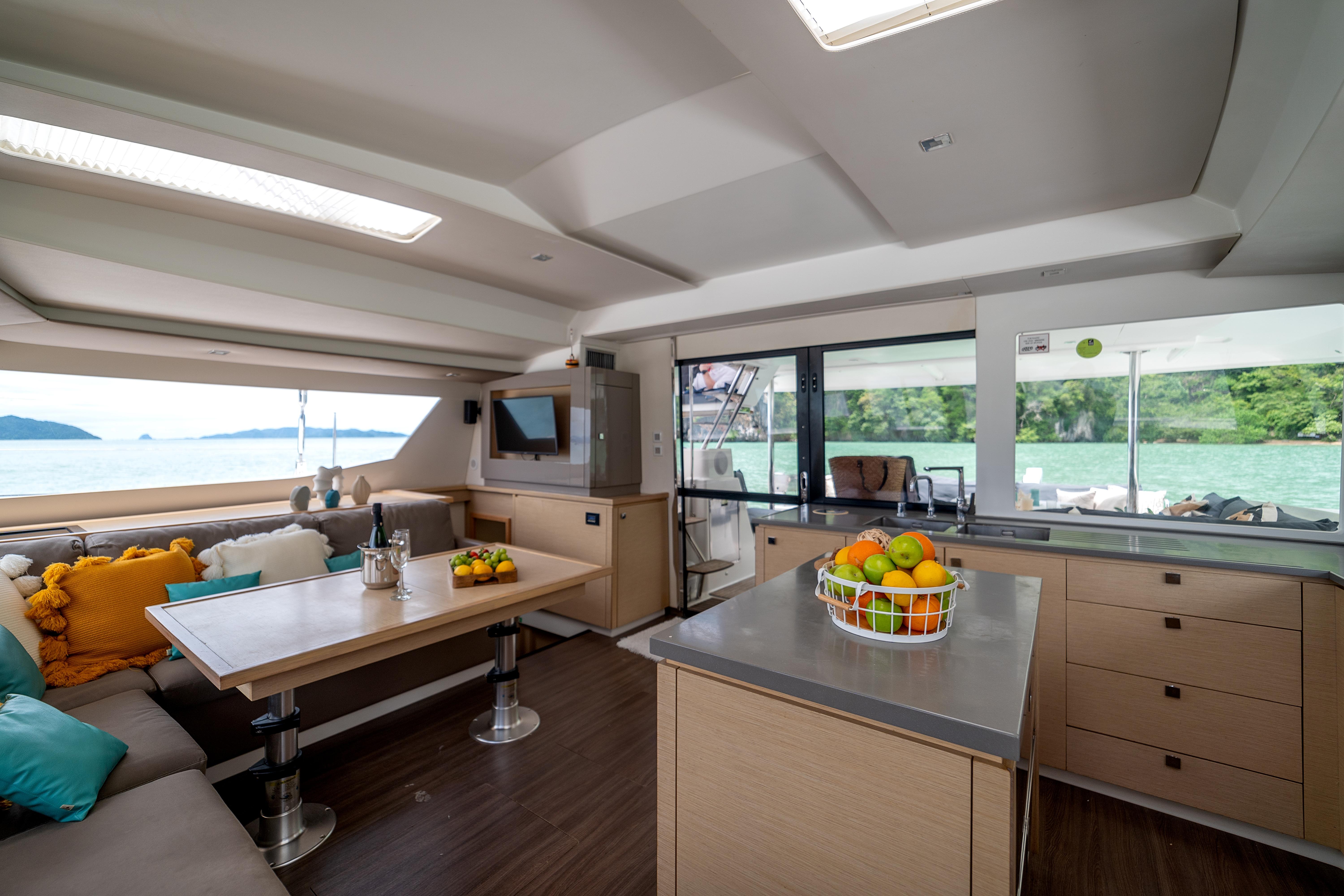 Luxurious interior of 2017 Fountaine Pajot SABA 50 catamaran with modern furnishings and scenic views.