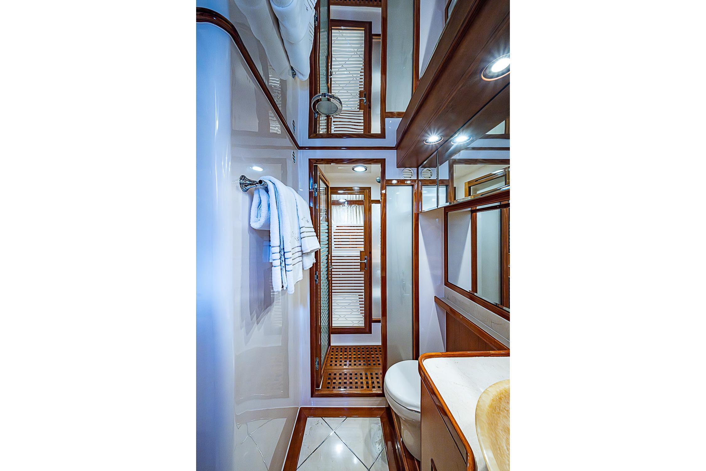 Luxurious bathroom interior of 2014 Marlow 80 Explorer yacht with elegant wood accents.