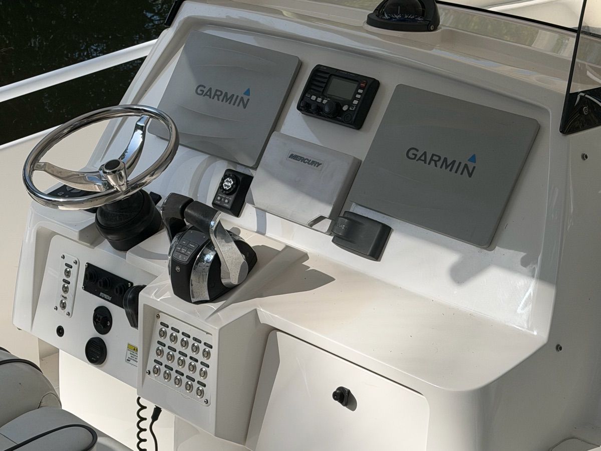 The image shows the helm of a 2014 Intrepid 375 Walkaround boat with Garmin equipment.