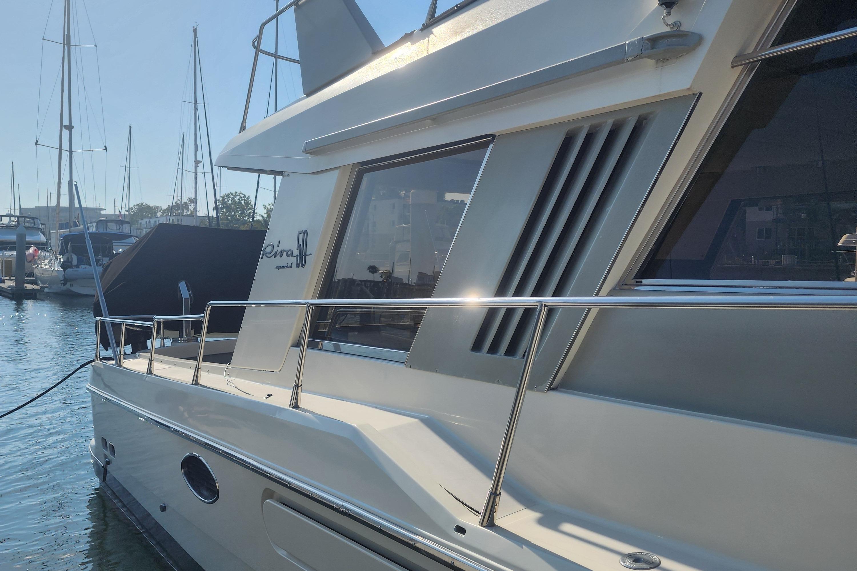 1987 Riva SuperAmerica yacht docked in marina, showcasing sleek design and elegant lines.