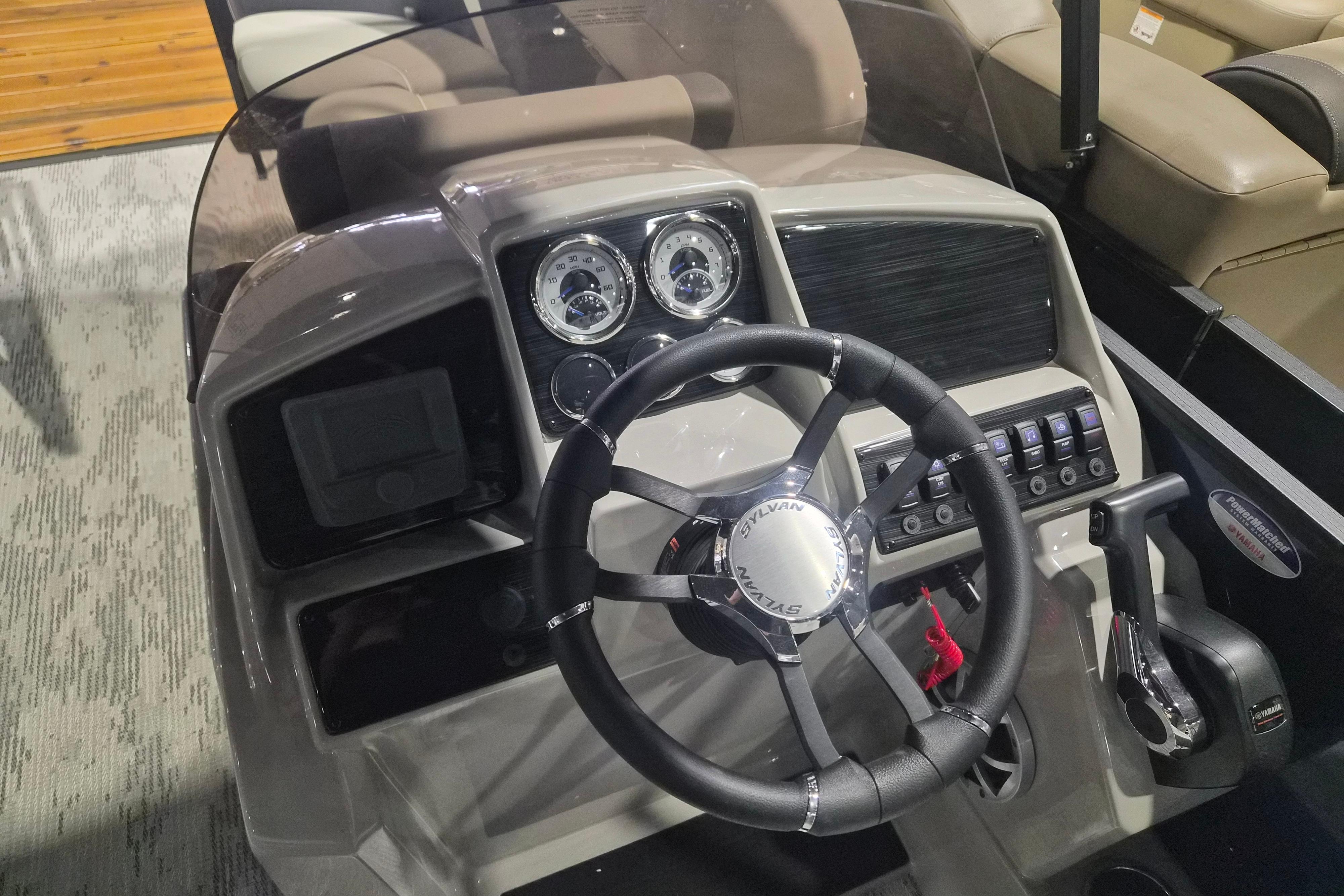 Steering console of 2026 Sylvan R-22 LZ DH boat with gauges and controls.