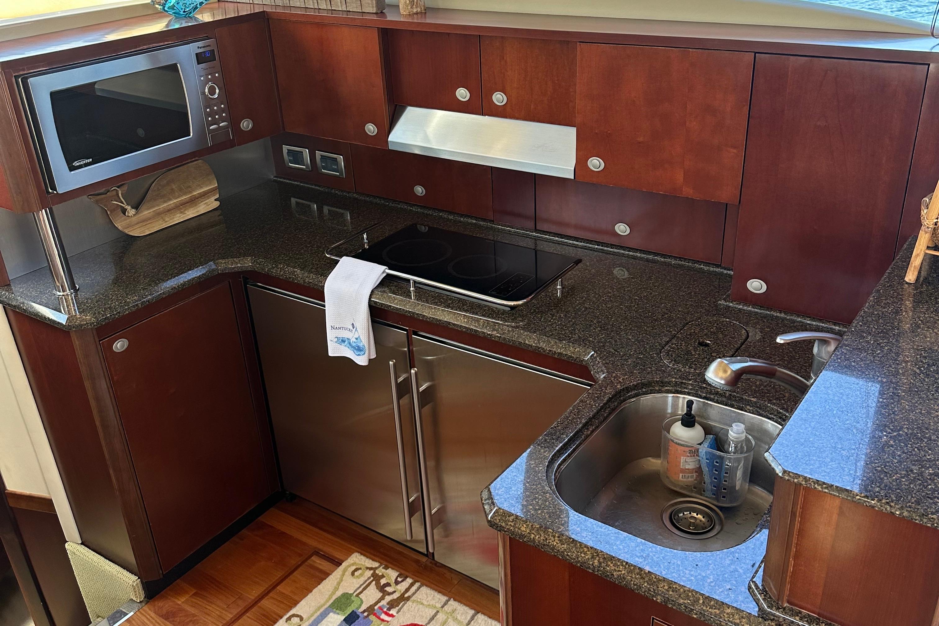 Luxurious kitchen in 2005 Sea Ray 500 Sedan Bridge yacht with modern appliances.