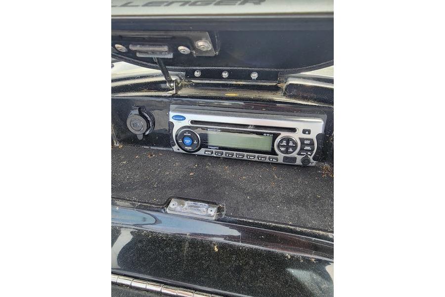 2012 Sea-Doo 180 Challenger boat stereo system in dashboard compartment.