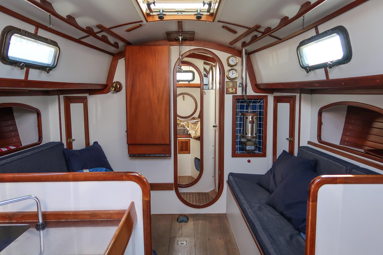 1989 Morris Ocean Series 32 yacht interior with wooden accents and cozy seating.