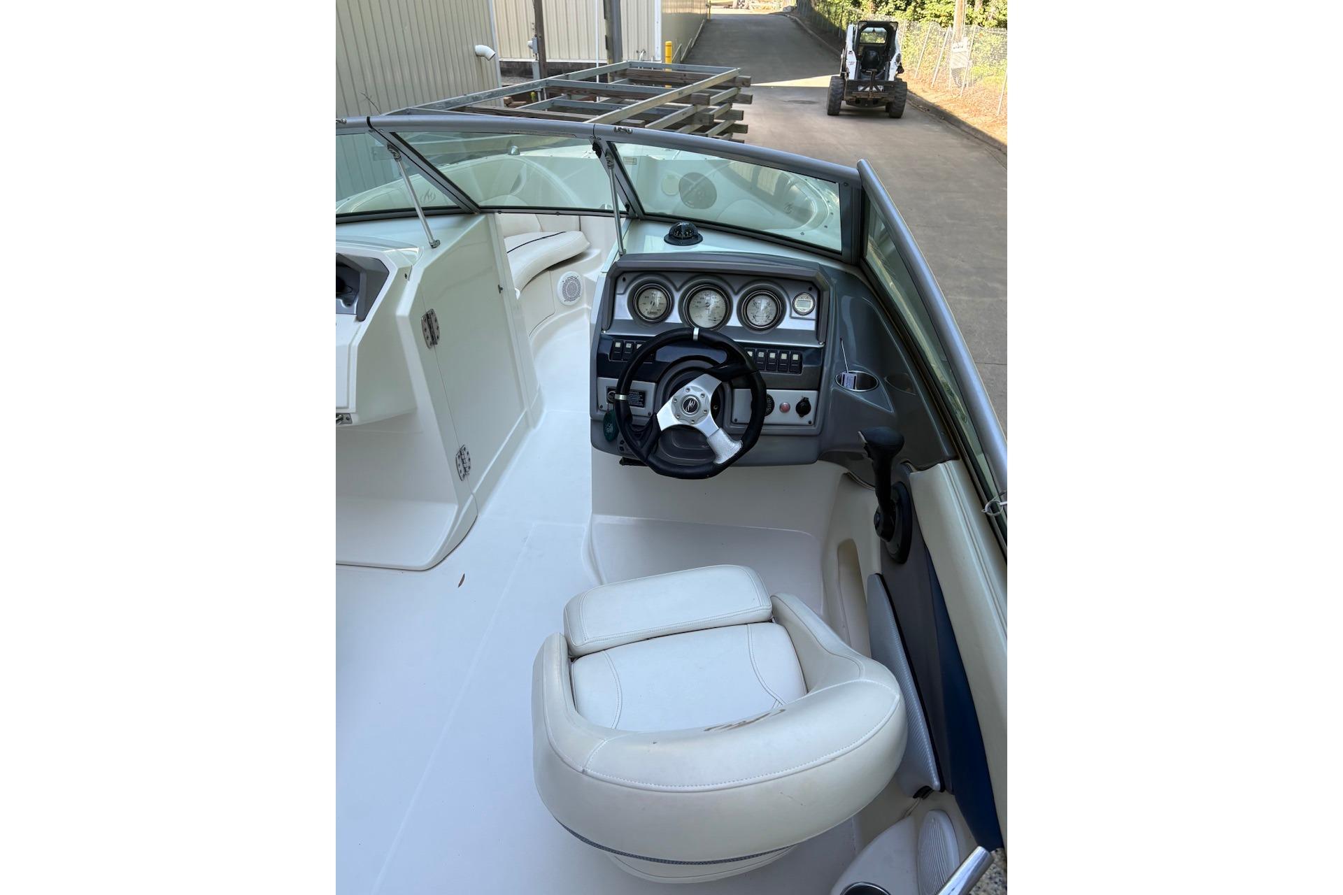2007 Monterey 220 Explorer boat interior with steering wheel and dashboard controls.