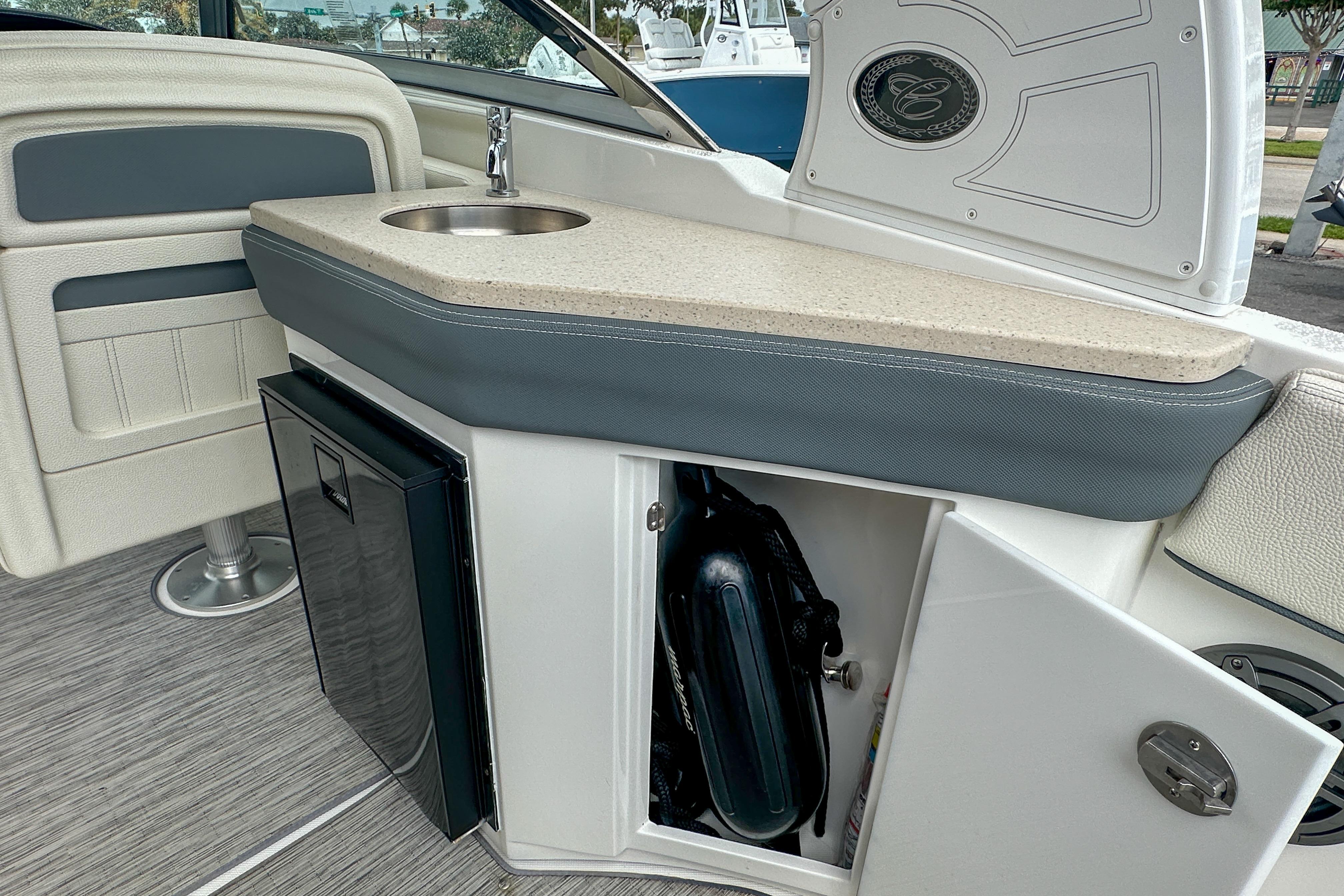 2022 Cobalt 25SC boat interior with sink, storage, and seating.