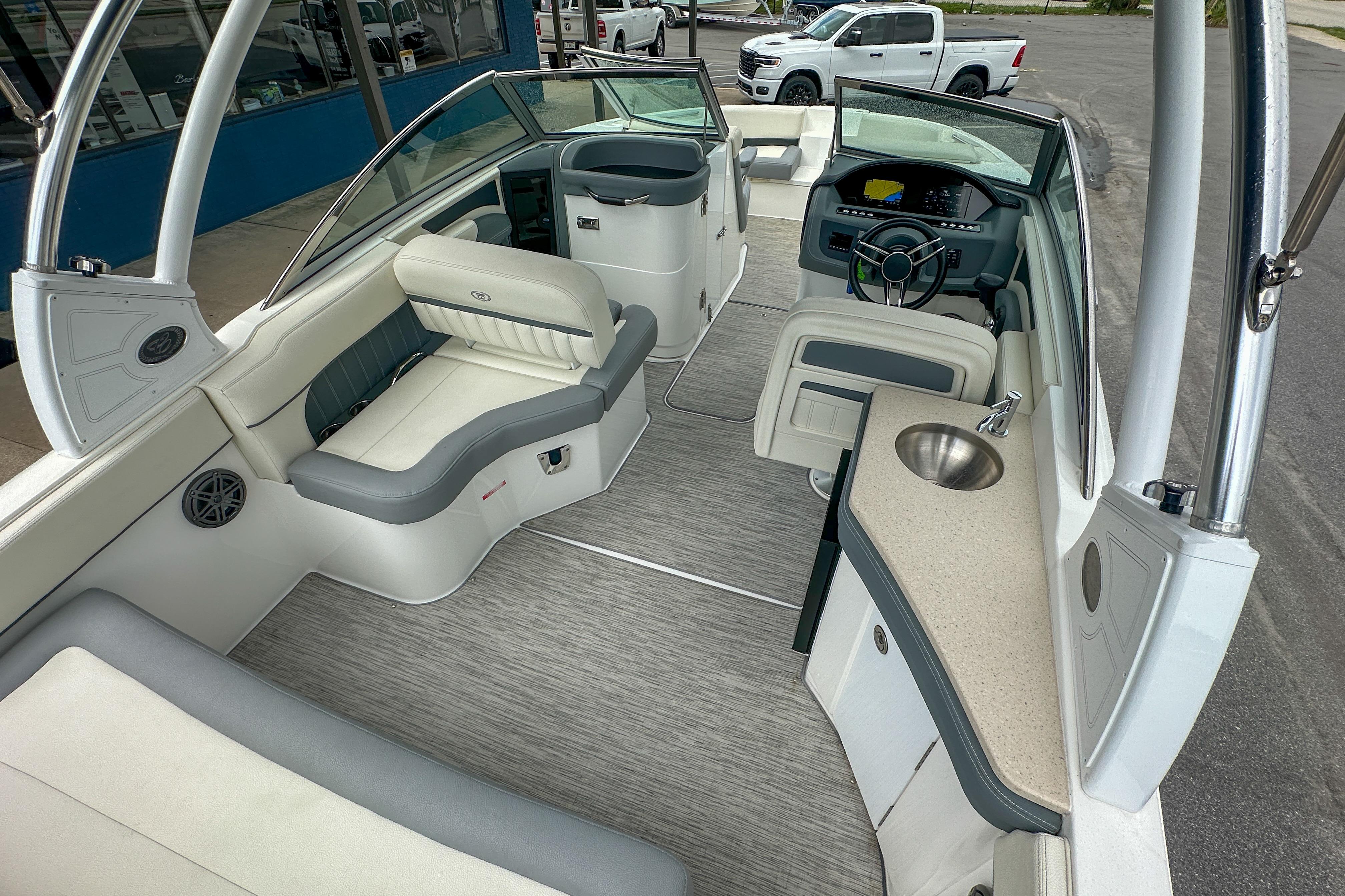 2022 Cobalt 25SC boat interior with seating, steering wheel, and sink.