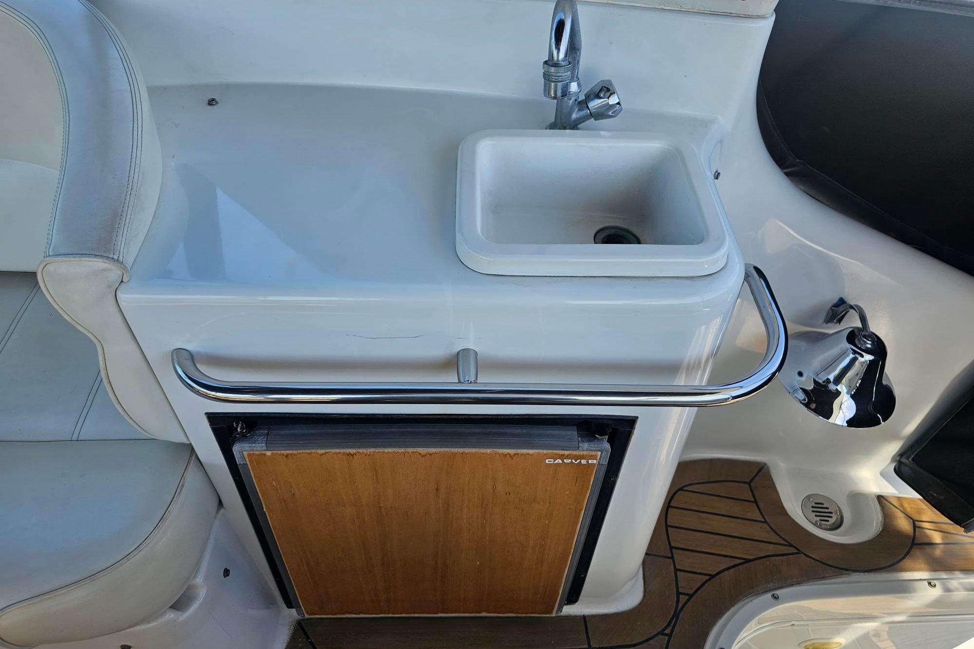 2002 Carver 450 Voyager Pilothouse sink and mini fridge on deck.