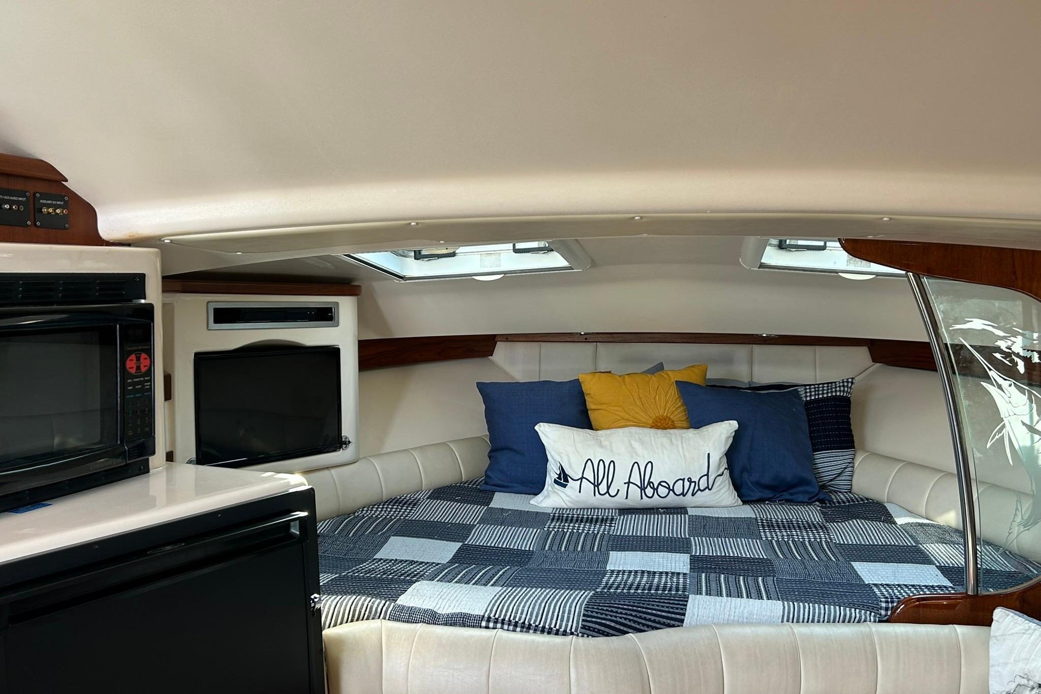 Cozy cabin interior of 2007 Grady-White Express 360 with bed and appliances.