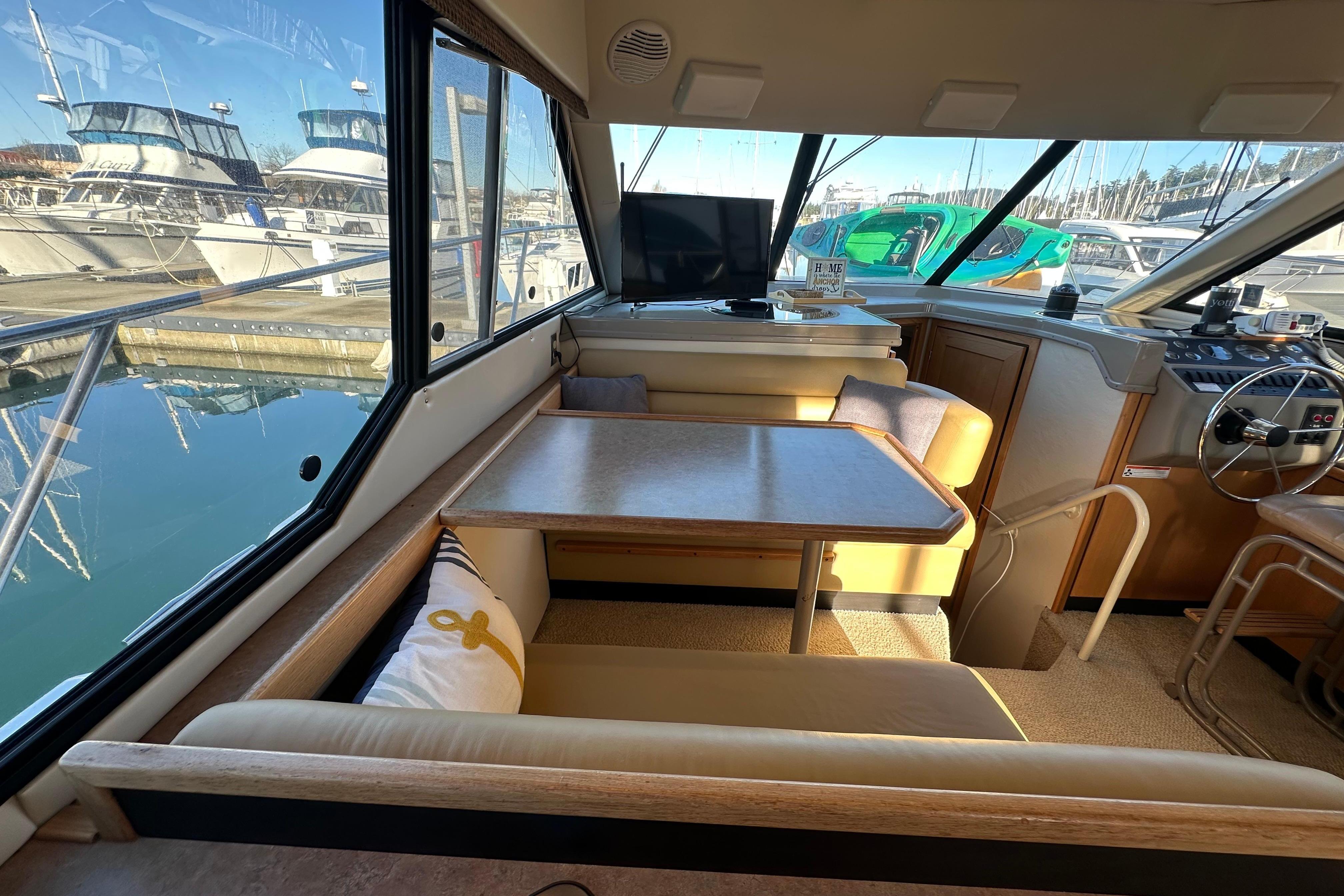 Interior of 2000 Bayliner 4087 Aft Cabin Motoryacht with dining area and helm.
