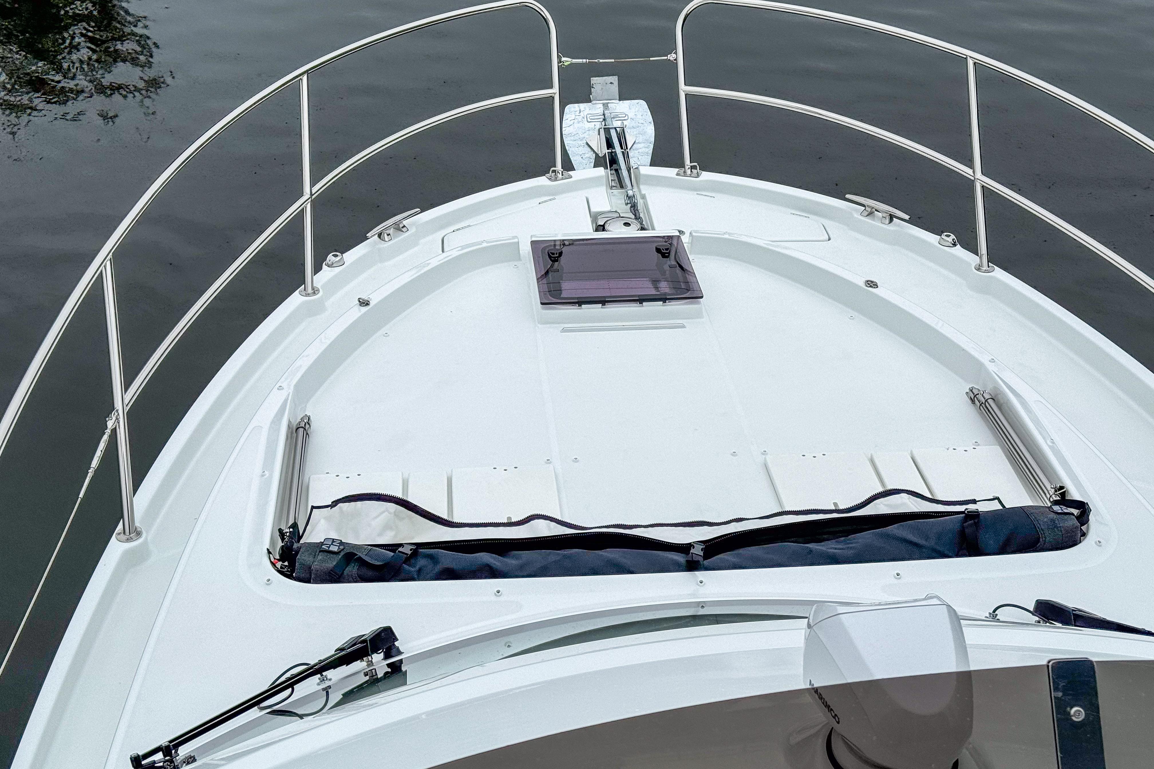 2026 Beneteau Antares 11 boat deck with railing and hatch, on calm water.