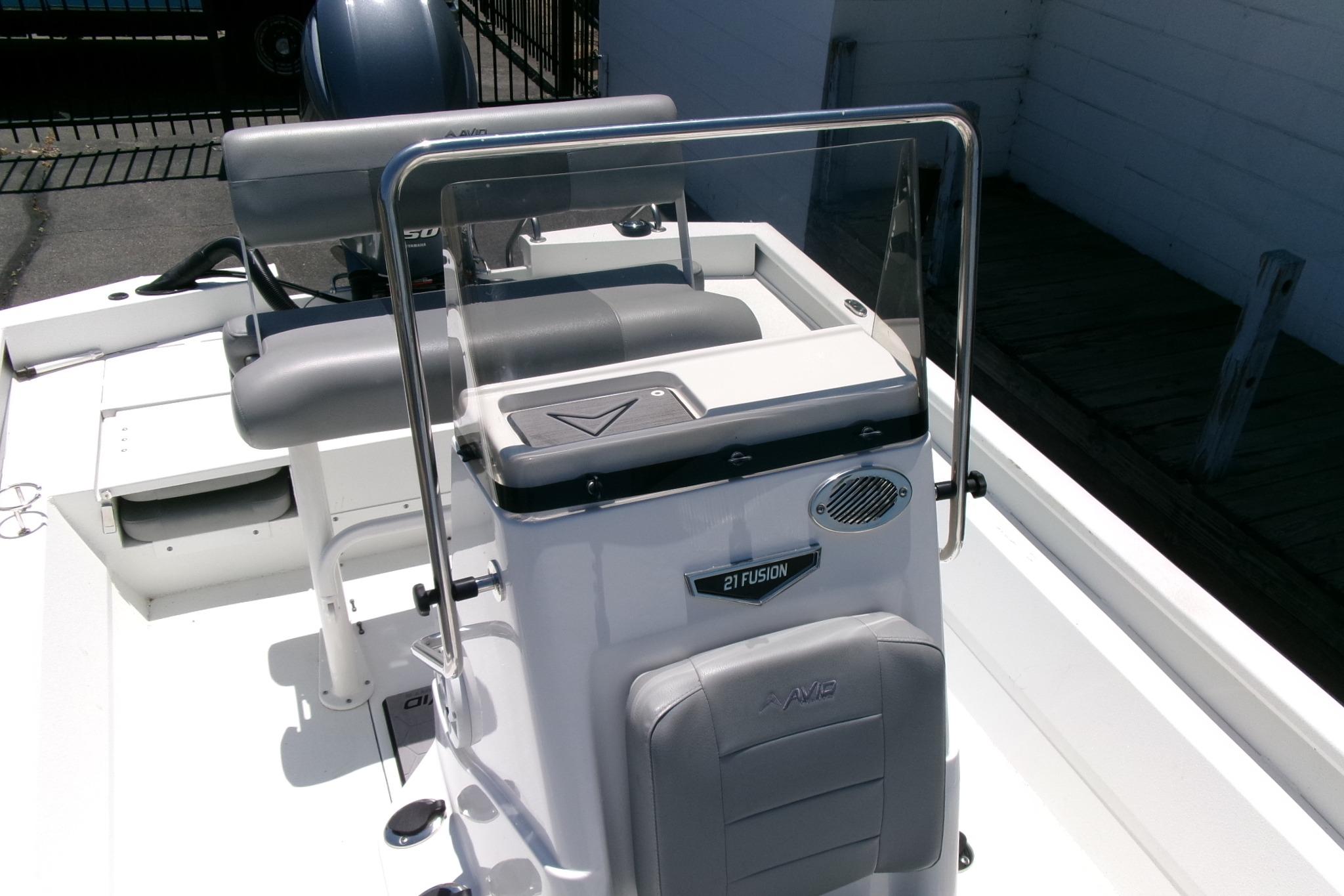 Avid 21 Fusion 2022 boat interior with seating and console, featuring modern design elements.