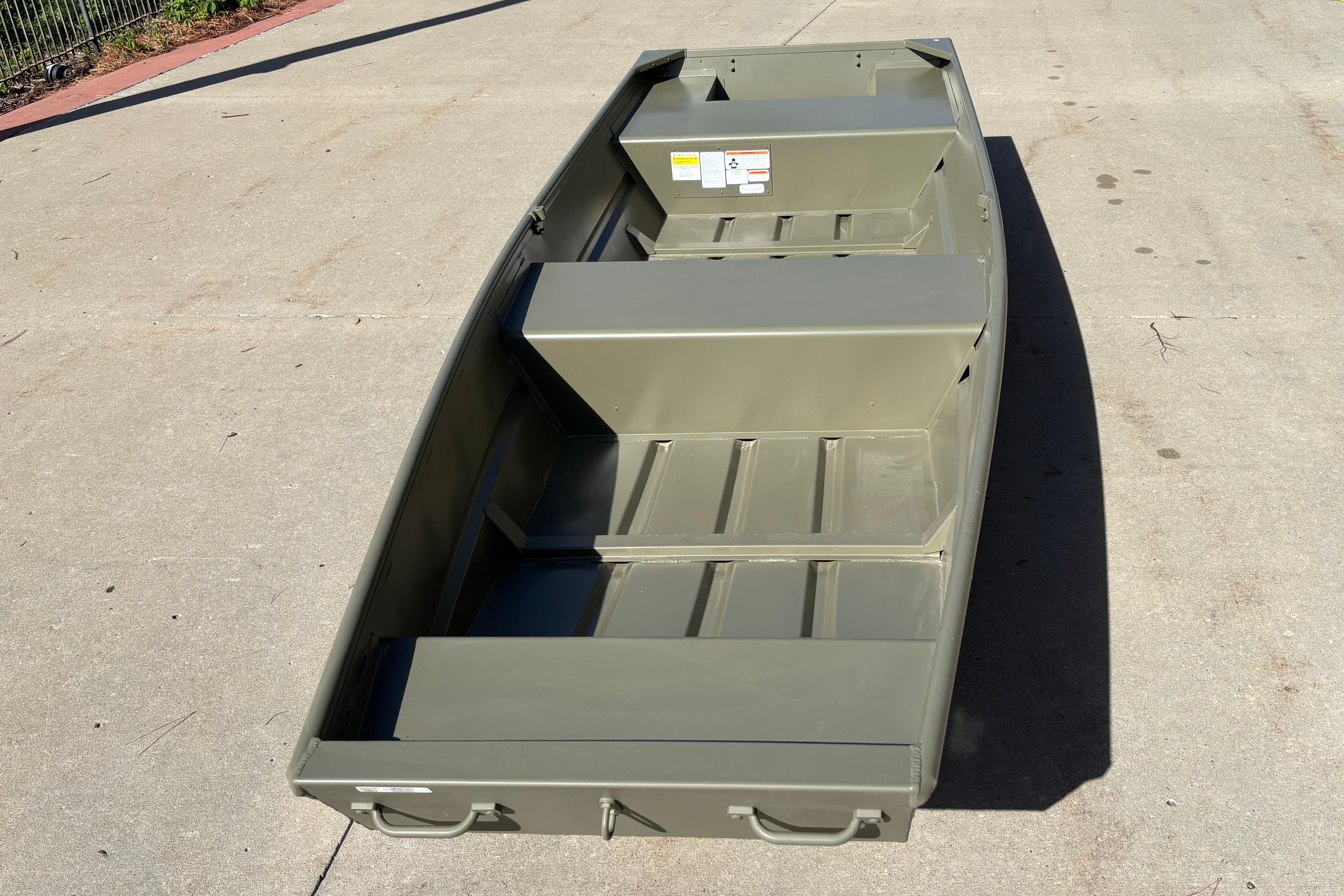 2026 Tracker Grizzly 14 Jon boat on concrete surface, showcasing interior layout.