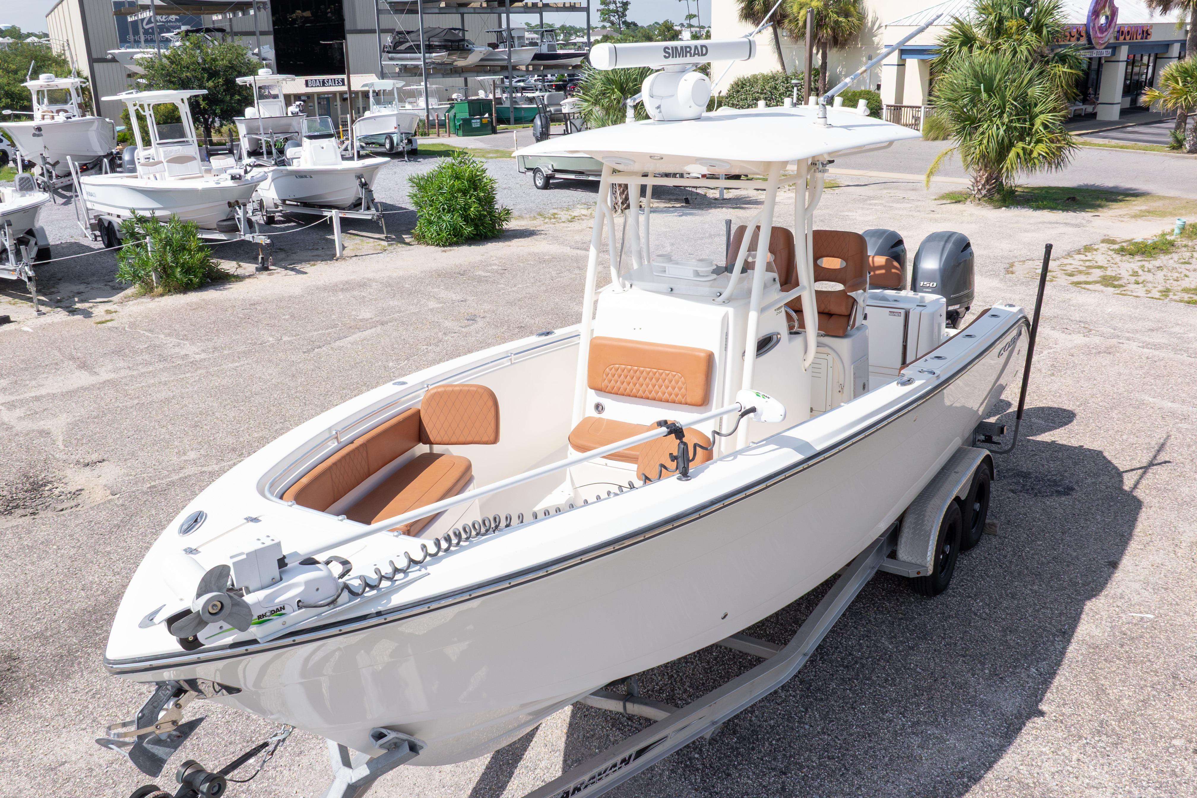 2017 Cobia 261 Center Console boat on trailer, parked outdoors at a marina.