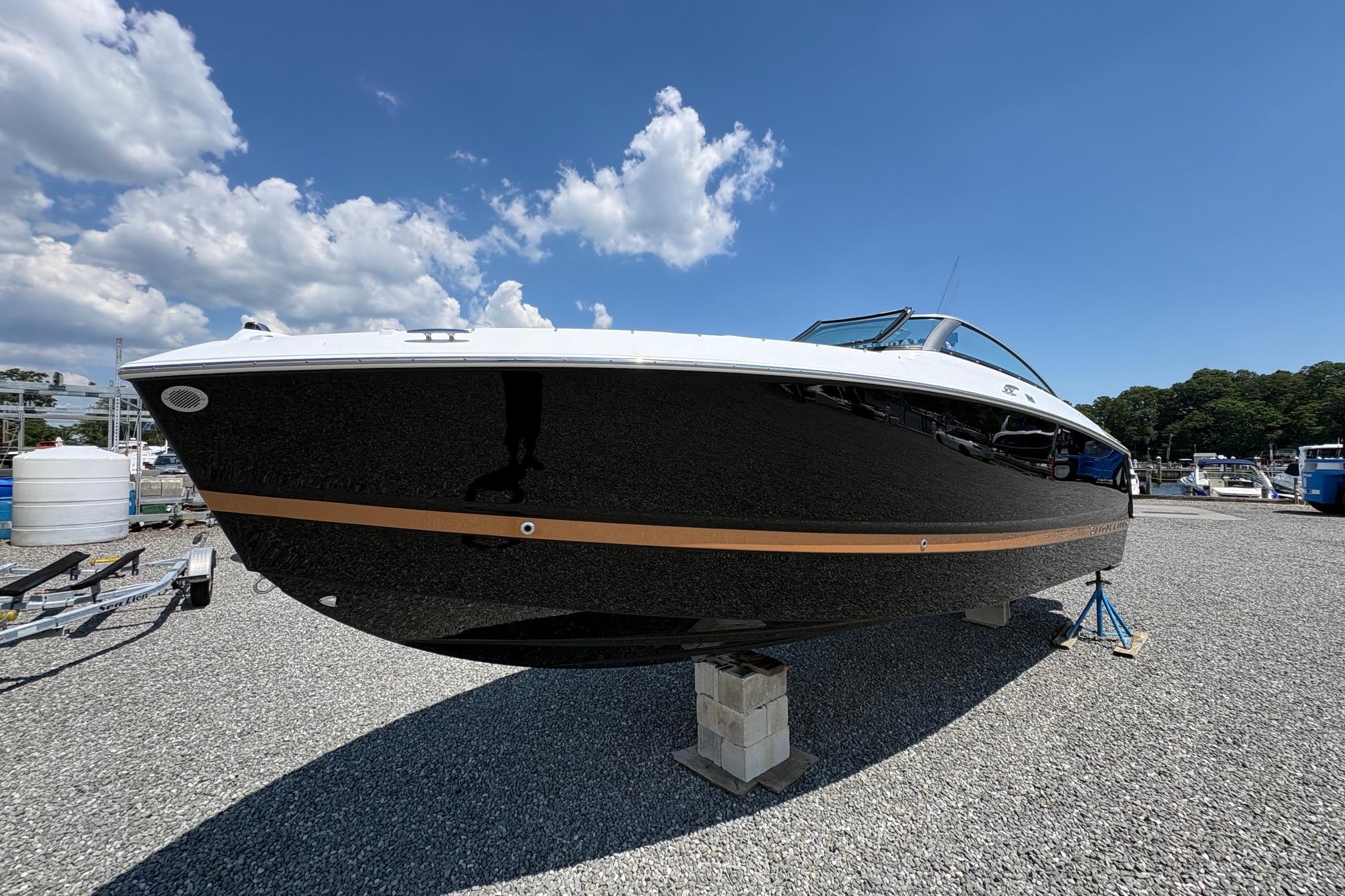 2026 Four Winns H6 boat on display under a clear blue sky.