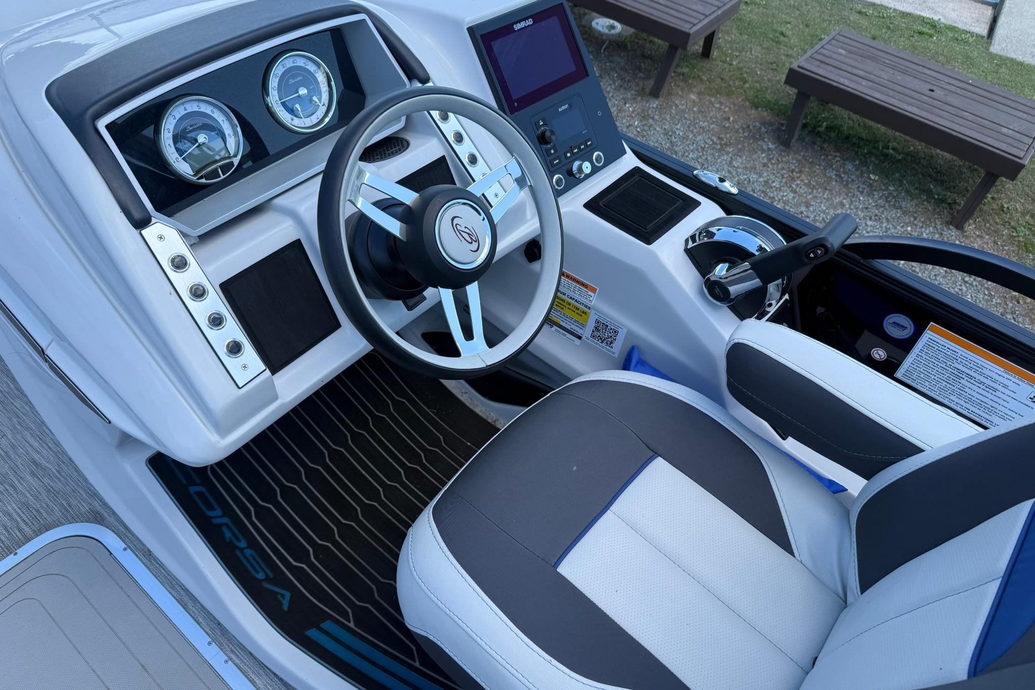 2023 Barletta Corsa 23U boat cockpit with steering wheel and control panel.