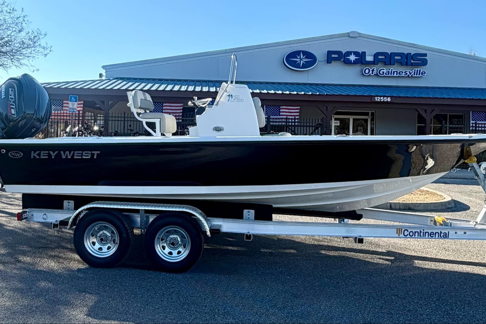 2026 Key West 210 Bay Reef boat on trailer at Polaris dealership.