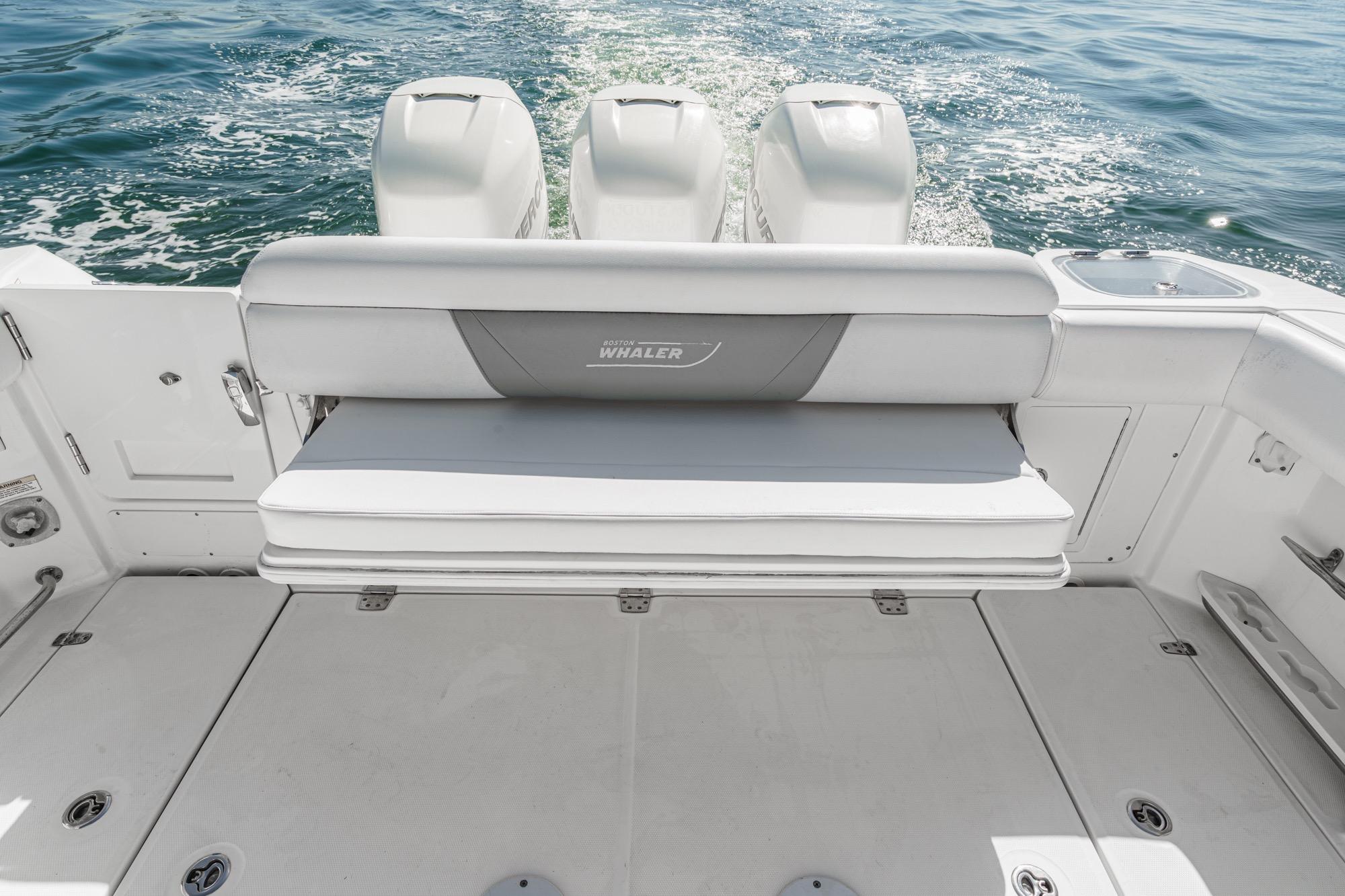 2015 Boston Whaler 370 Outrage boat with triple engines and rear seating.