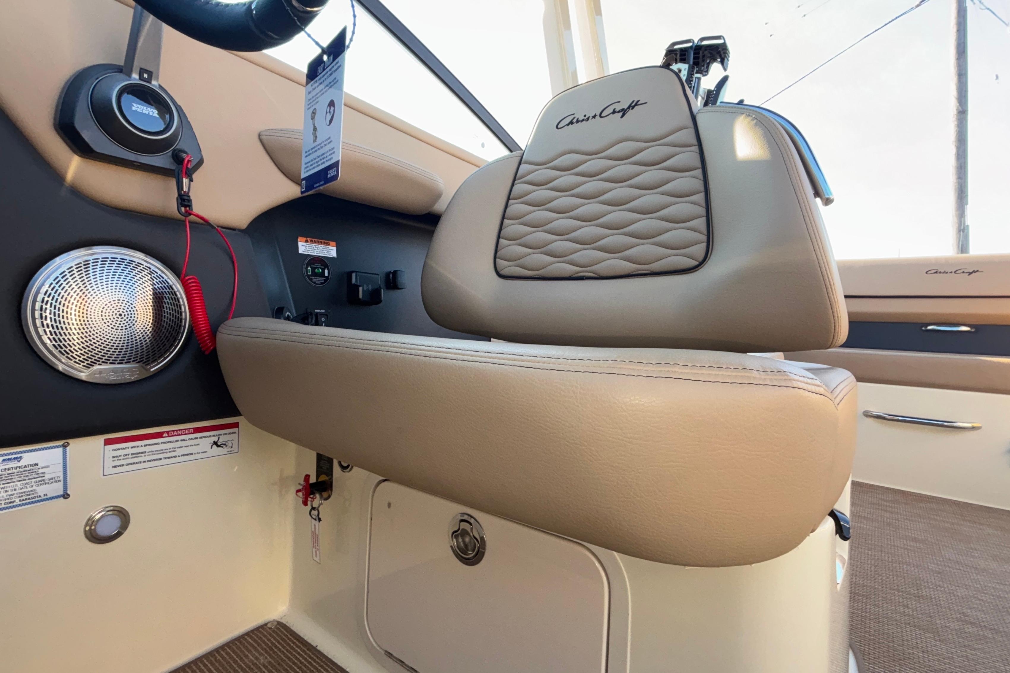 2026 Chris-Craft Sportster 28 interior with beige leather seating and speaker system.
