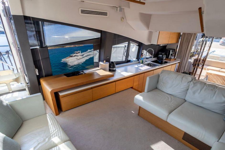Luxurious interior of 2009 Sealine T60 yacht with modern furnishings and large windows.