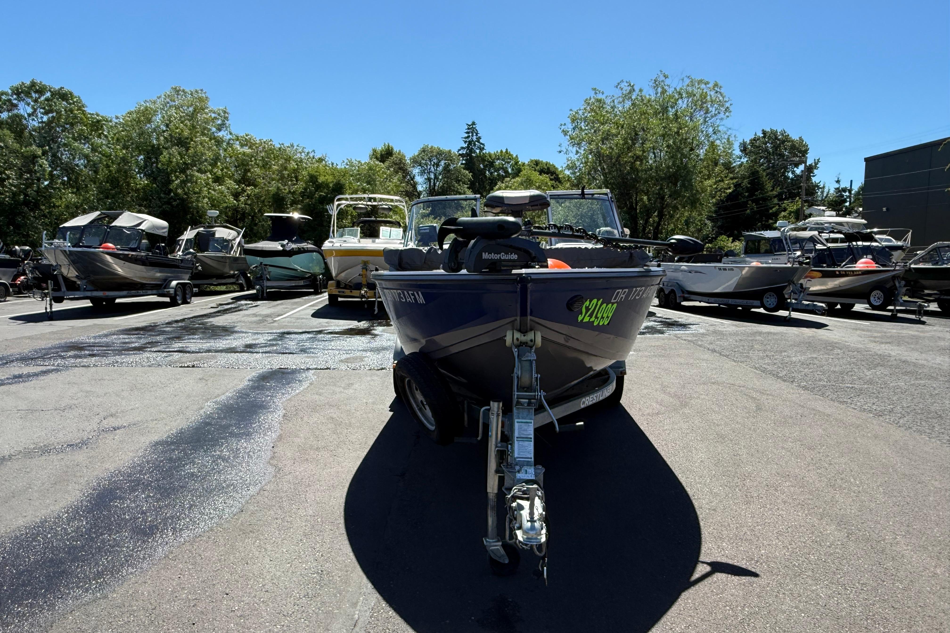 2016 Crestliner 1700 Vision boat on trailer in outdoor lot, surrounded by other boats.