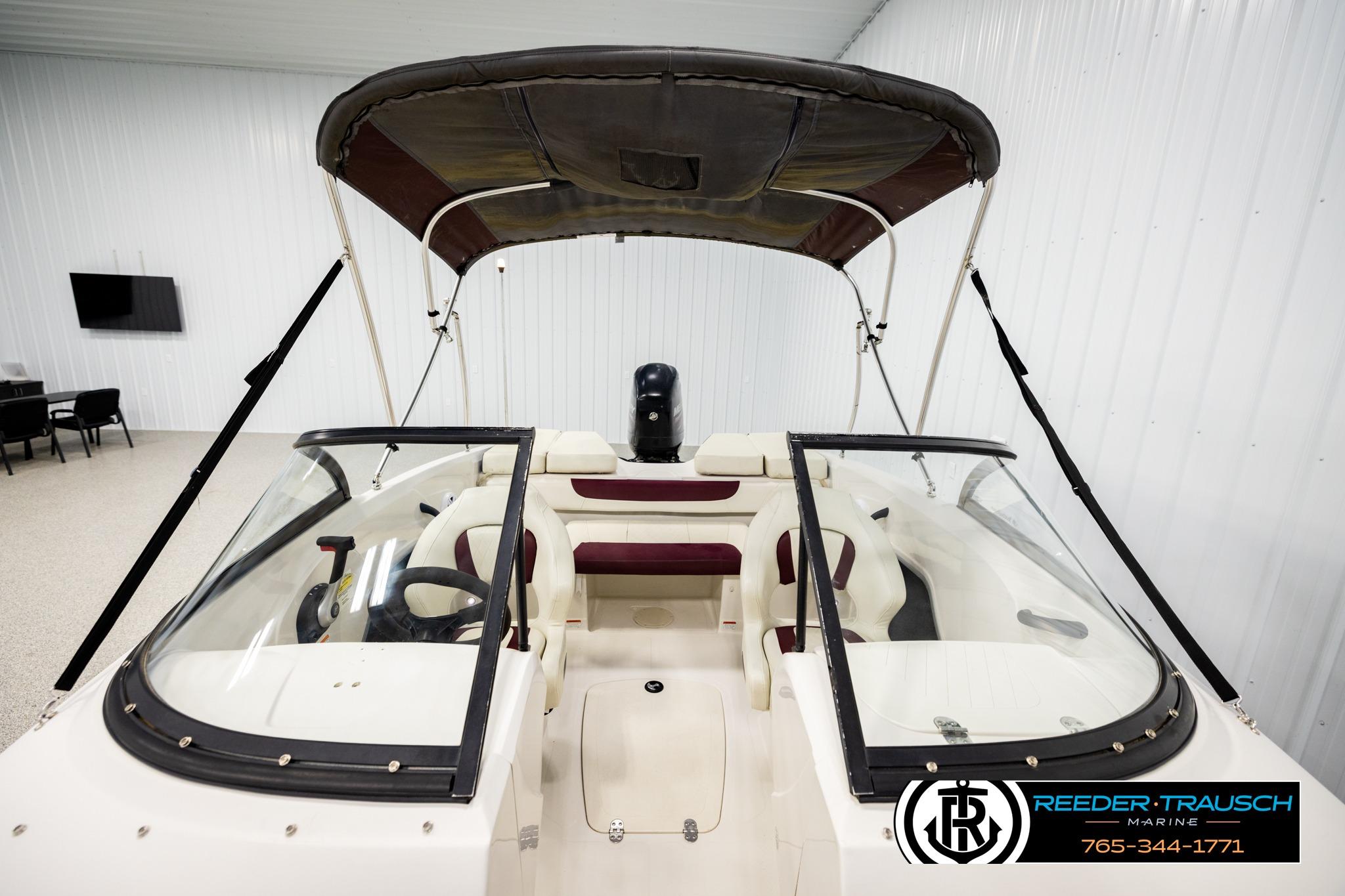 2016 Tahoe 450 TS boat with canopy in indoor showroom.