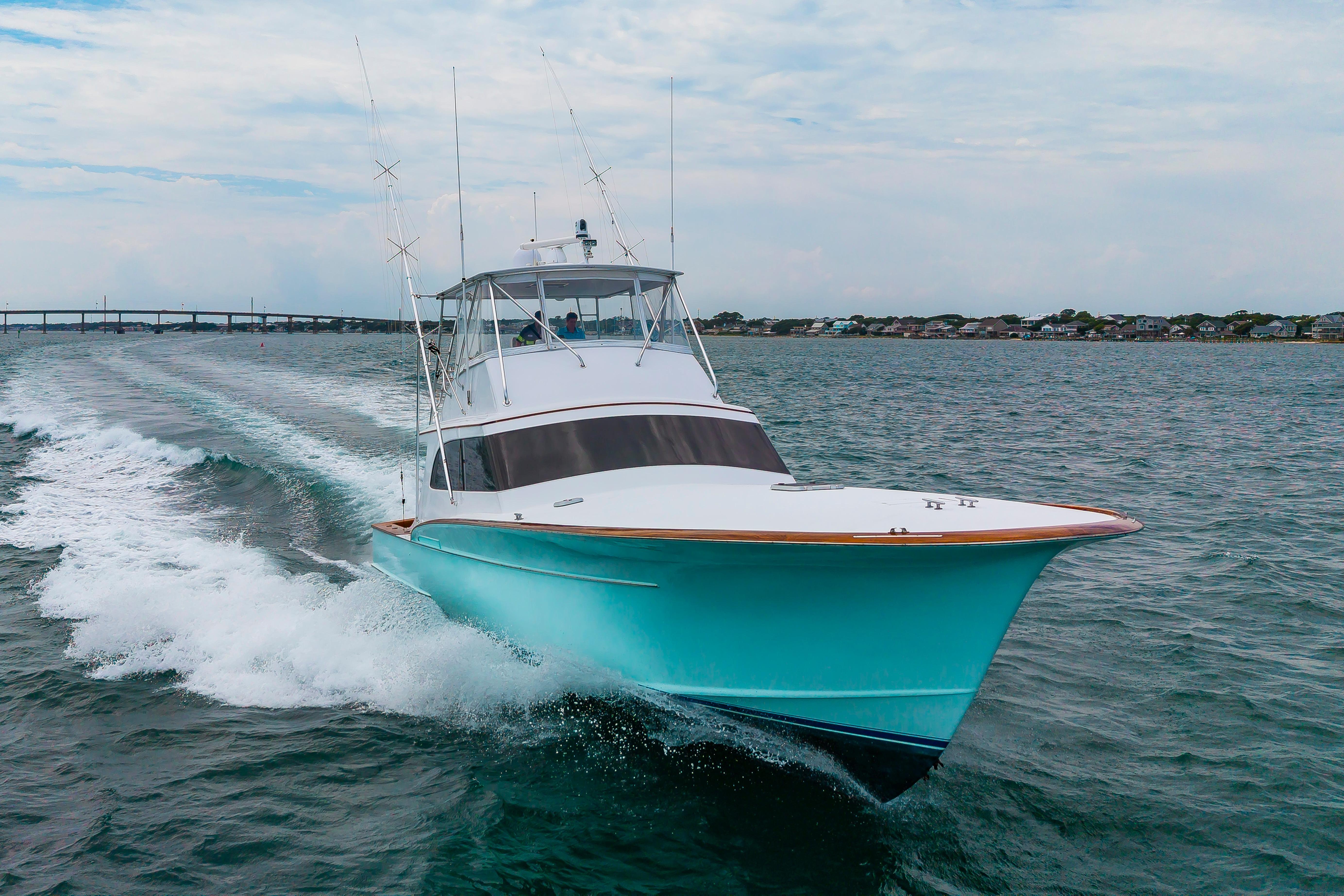 Custom Carolina Scarborough 56 Convertible yacht cruising on open water, 1993 model.