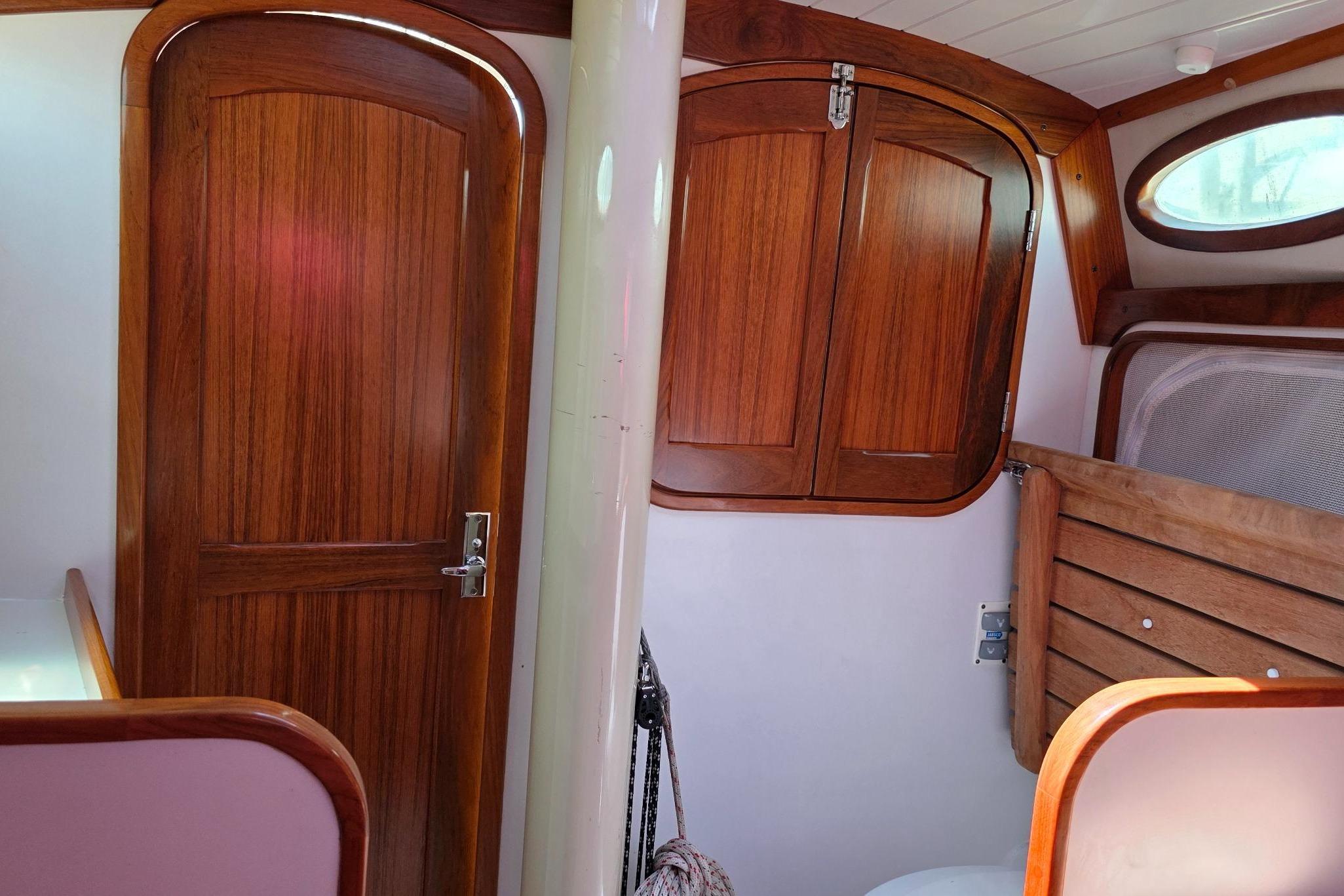 Interior of 2020 Alerion Express 33 sailboat with wooden doors and cabinetry.