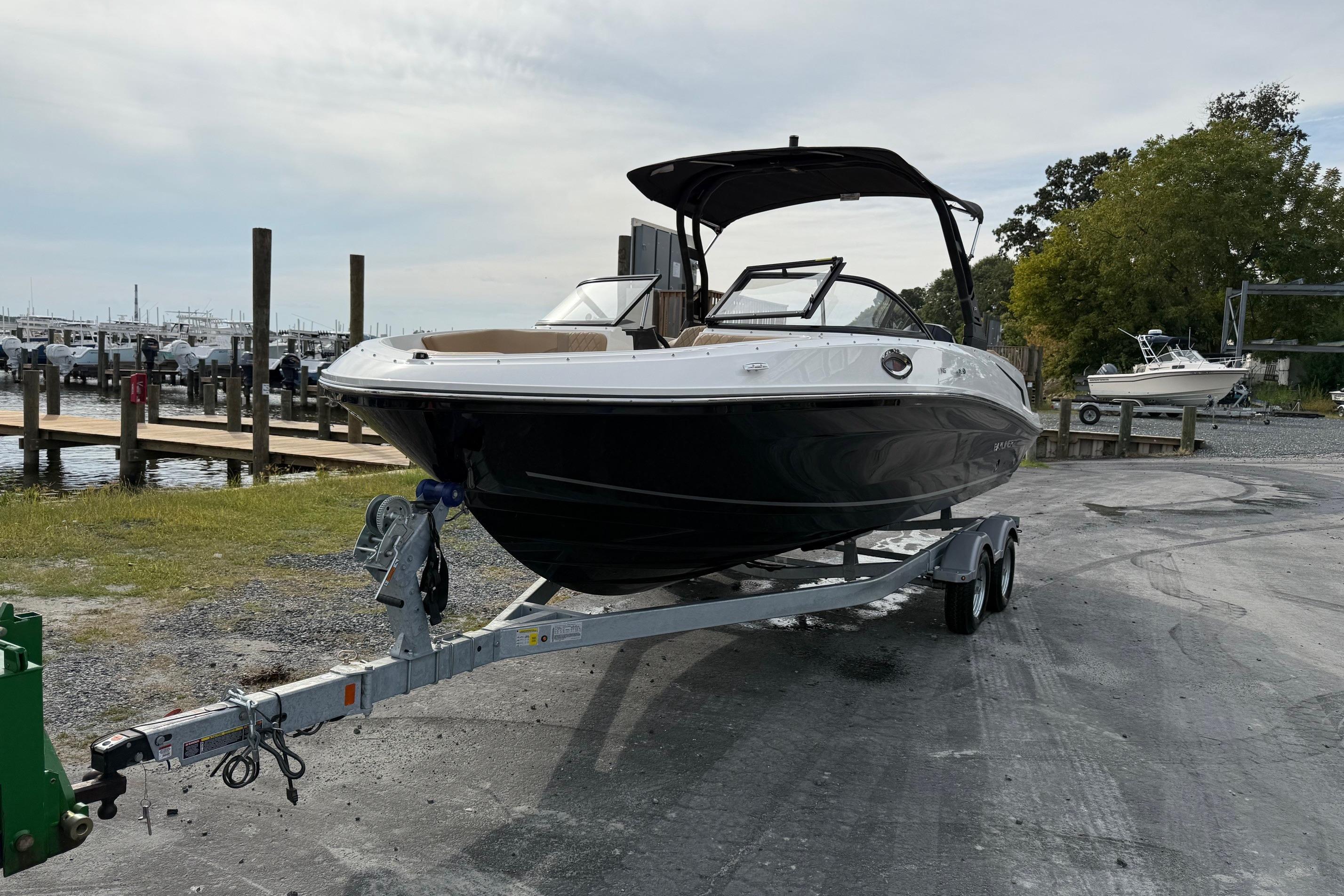 2026 Bayliner VR6 Bowrider OB on trailer at marina, ready for launch.
