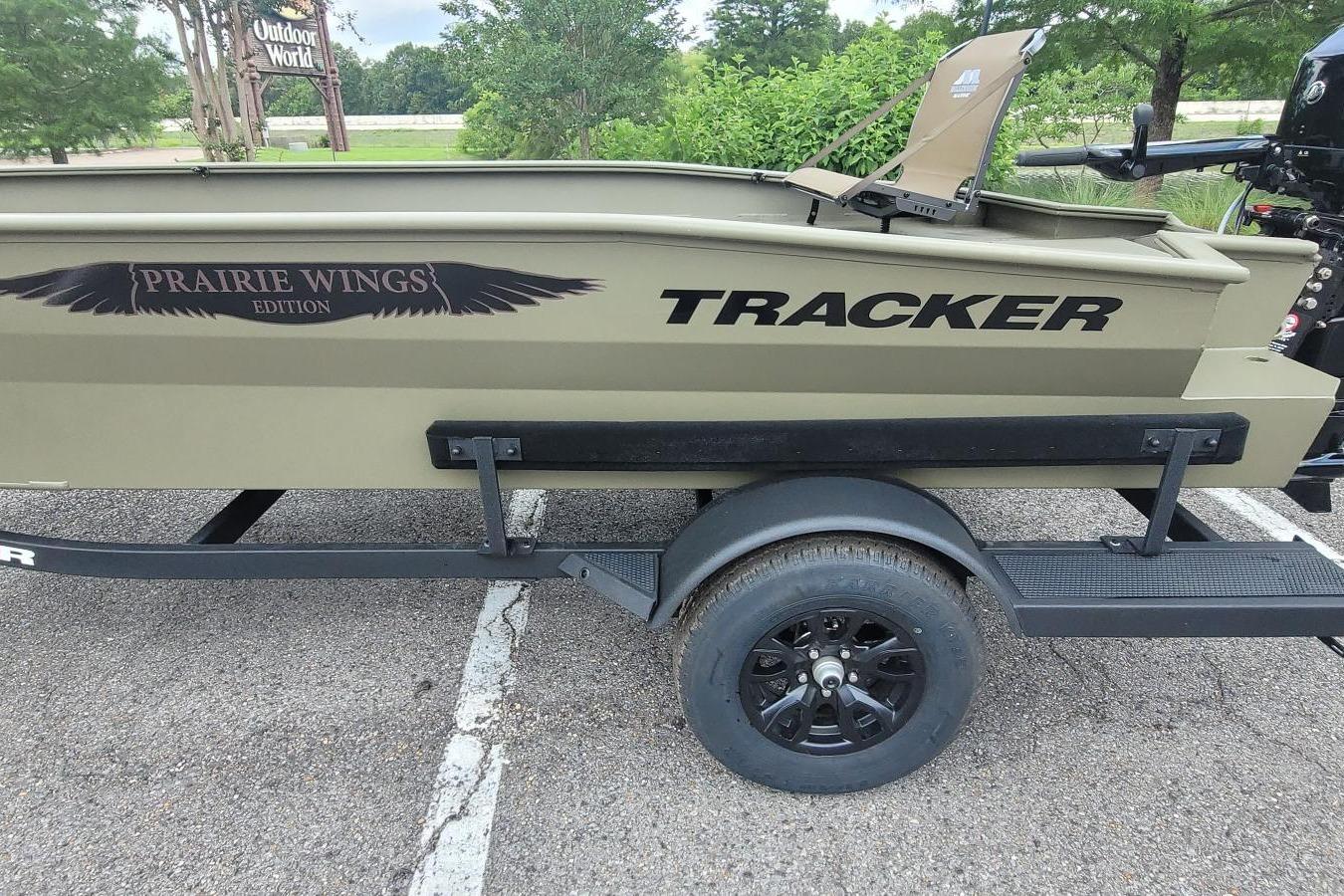 2026 Tracker Grizzly 1650 T Prairie Wings Edition boat on trailer, parked outdoors.